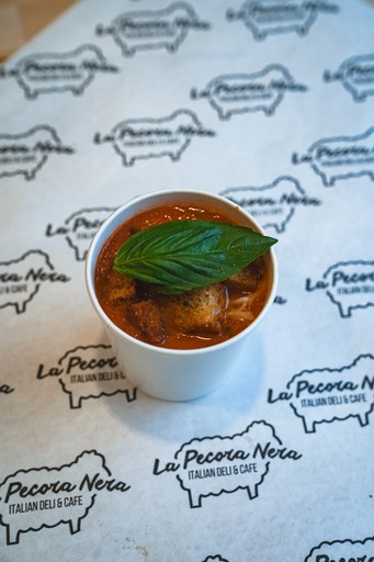 corn cob with the topping served in a black bowl