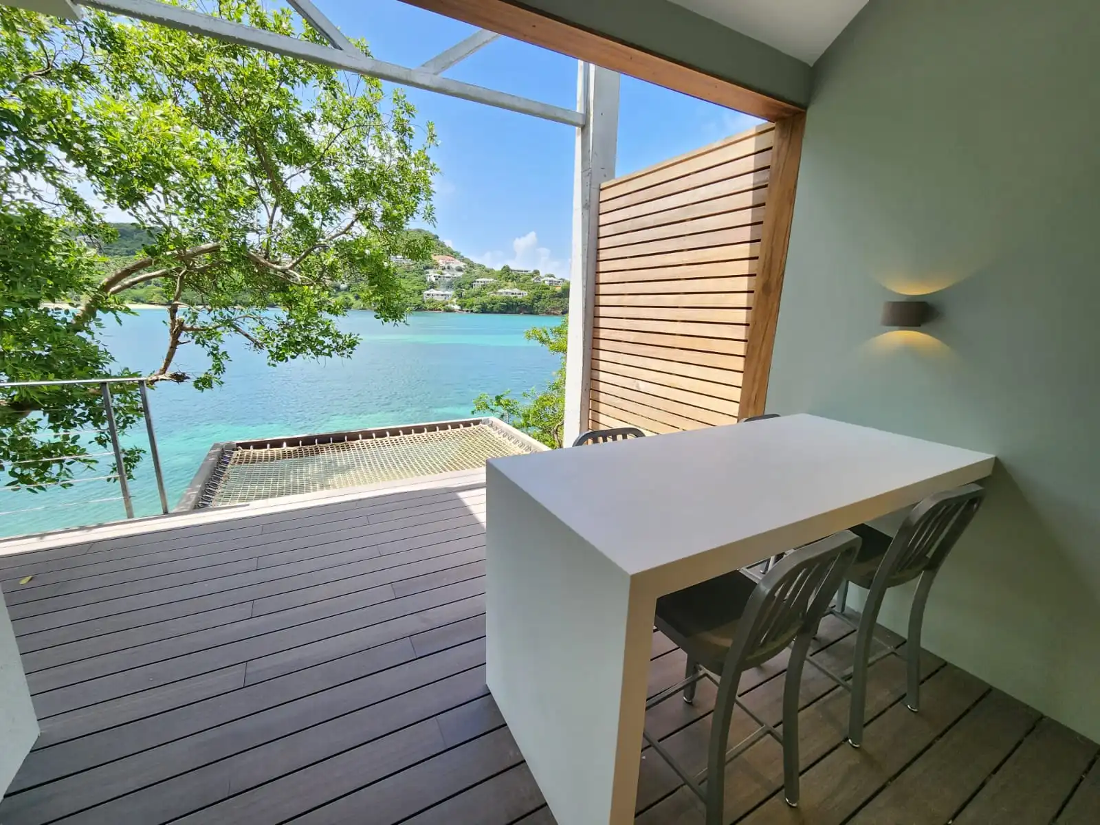 Interior balcony bar with floor-to-ceiling opening and Caribbean sea views in St. Lucia residence