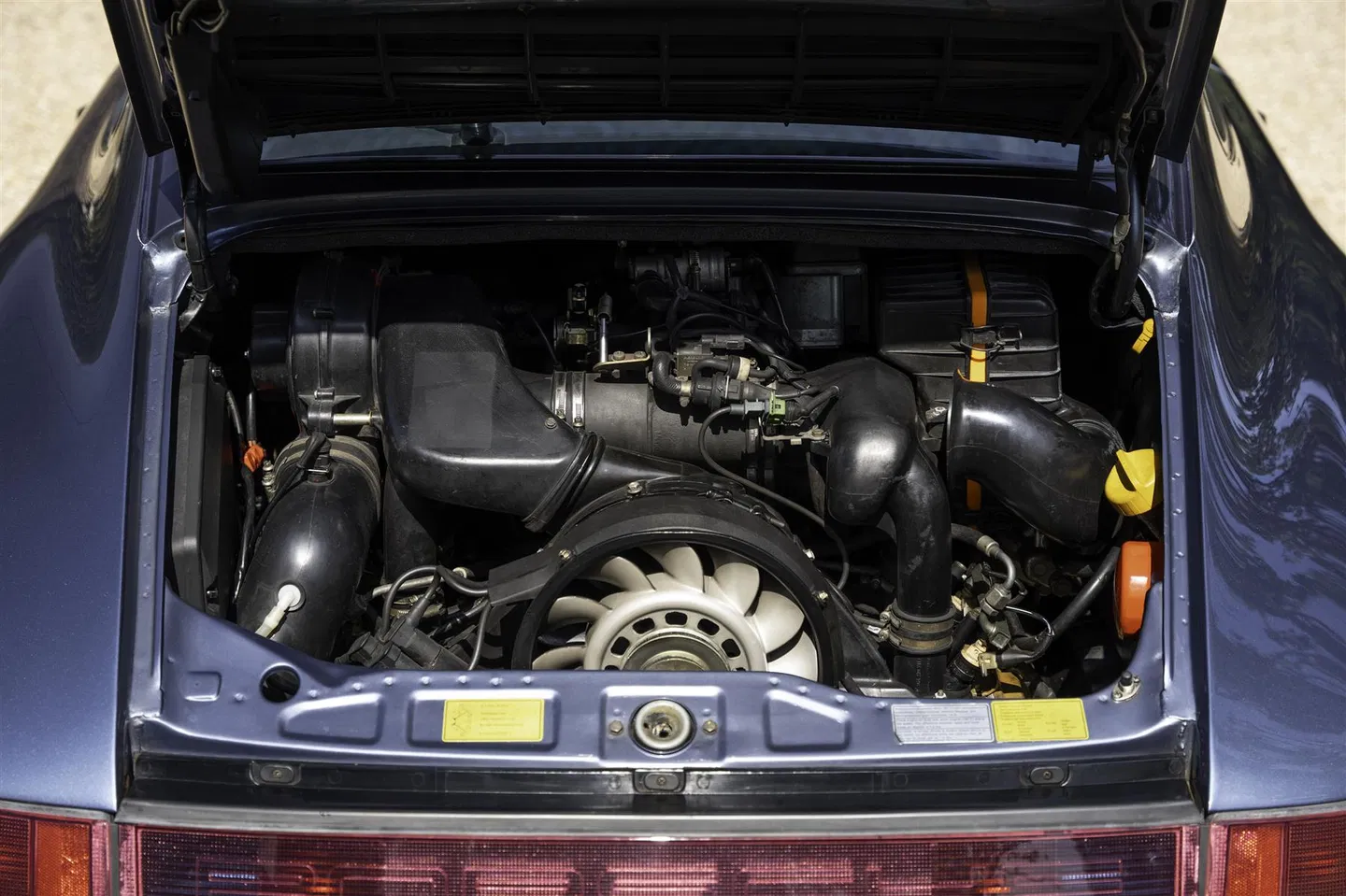Open engine lid showing the 3.6-litre flat-six and cooling fan