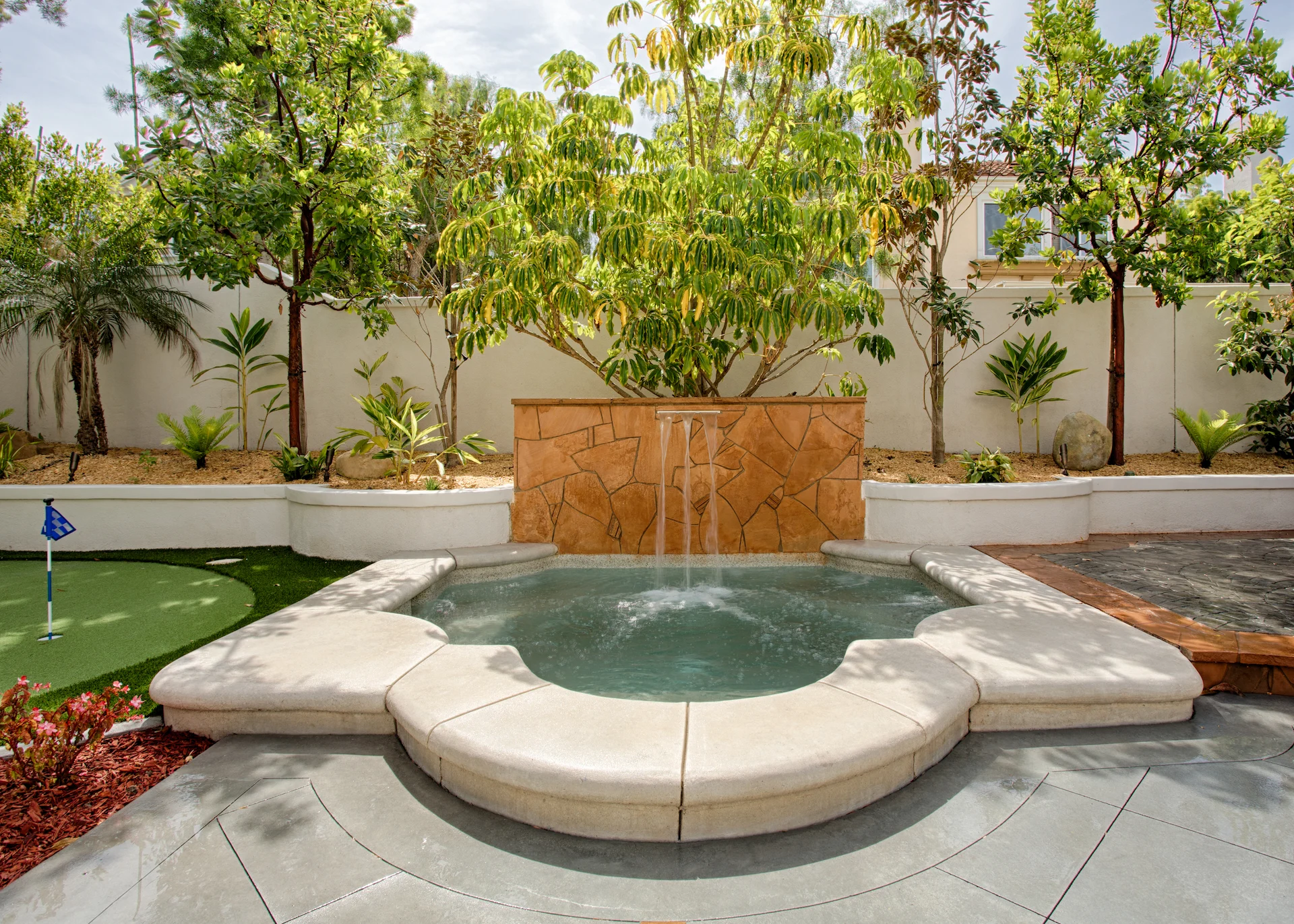 View of the exterior fountain water feature, adding a serene and artistic touch to the outdoor space of the Harbor Cove home.