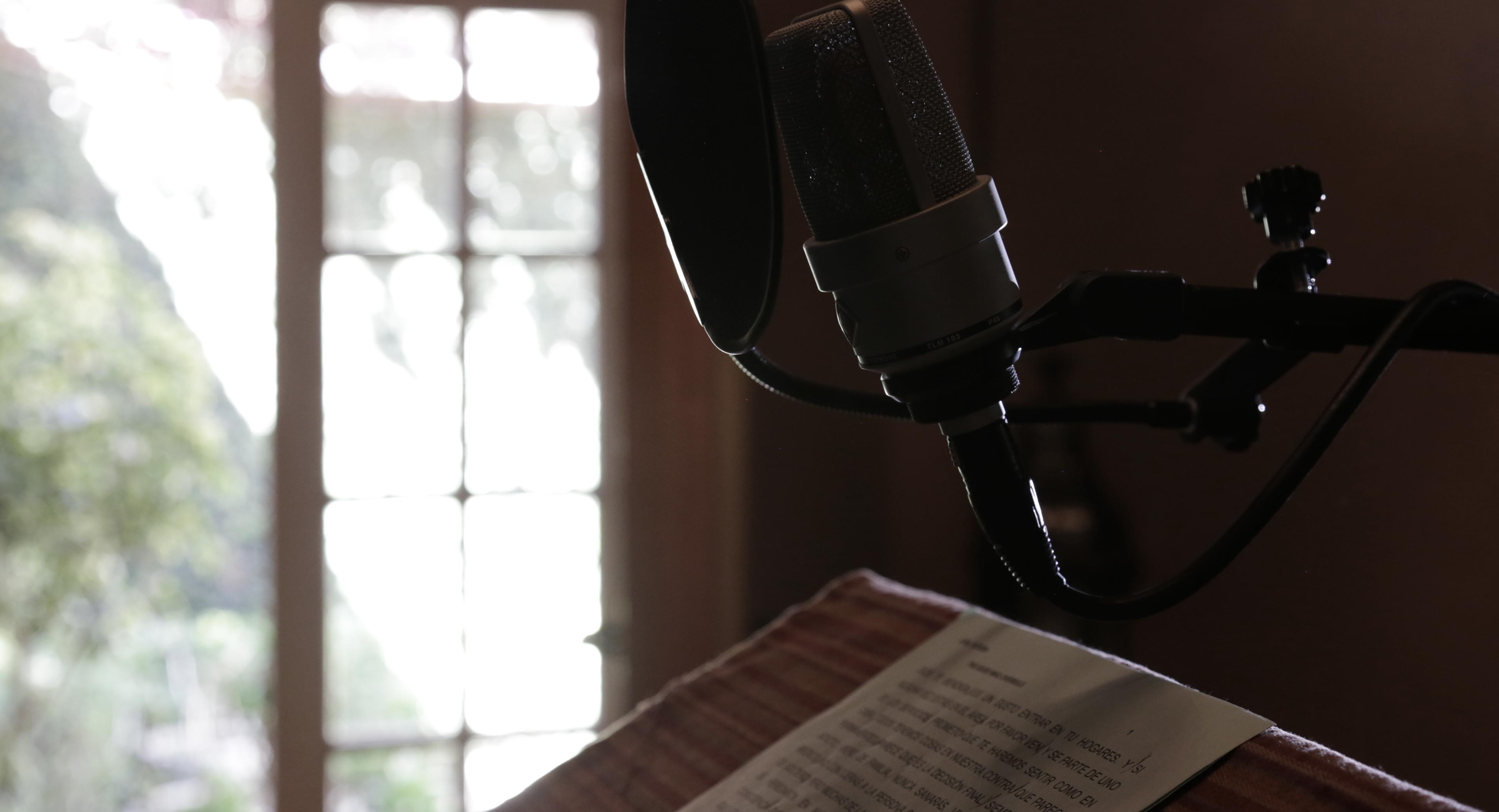 Four diverse professionals collaboratively working on a laptop, with one person pointing at the screen while others observe.