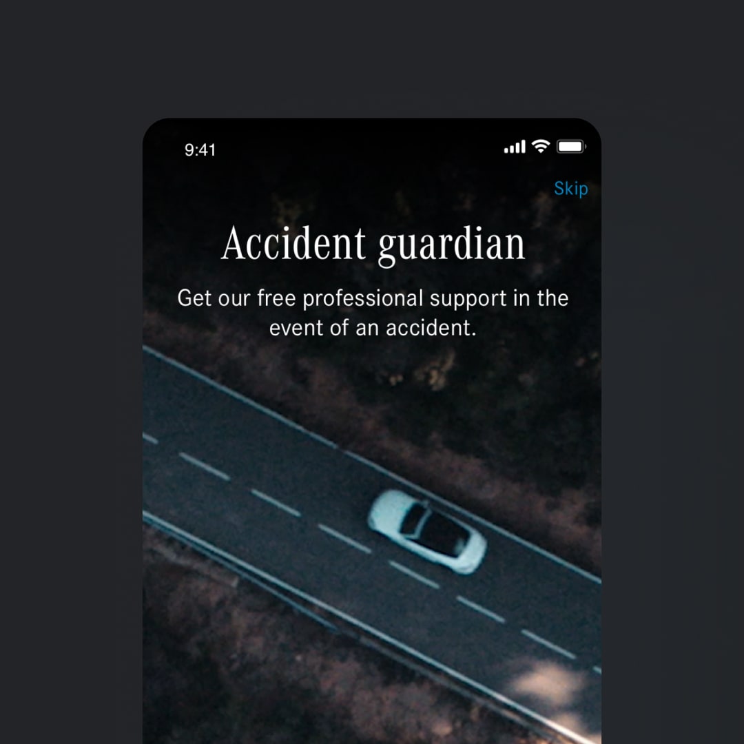 Onboarding screen for the Accident Guardian feature, showing white serif text over an aerial night photograph of a lone car on a motorway, with a Skip link in the top right corner.