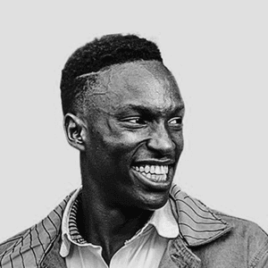 A black and white photo of a smiling man, showcasing his joyful expression and friendly demeanor.