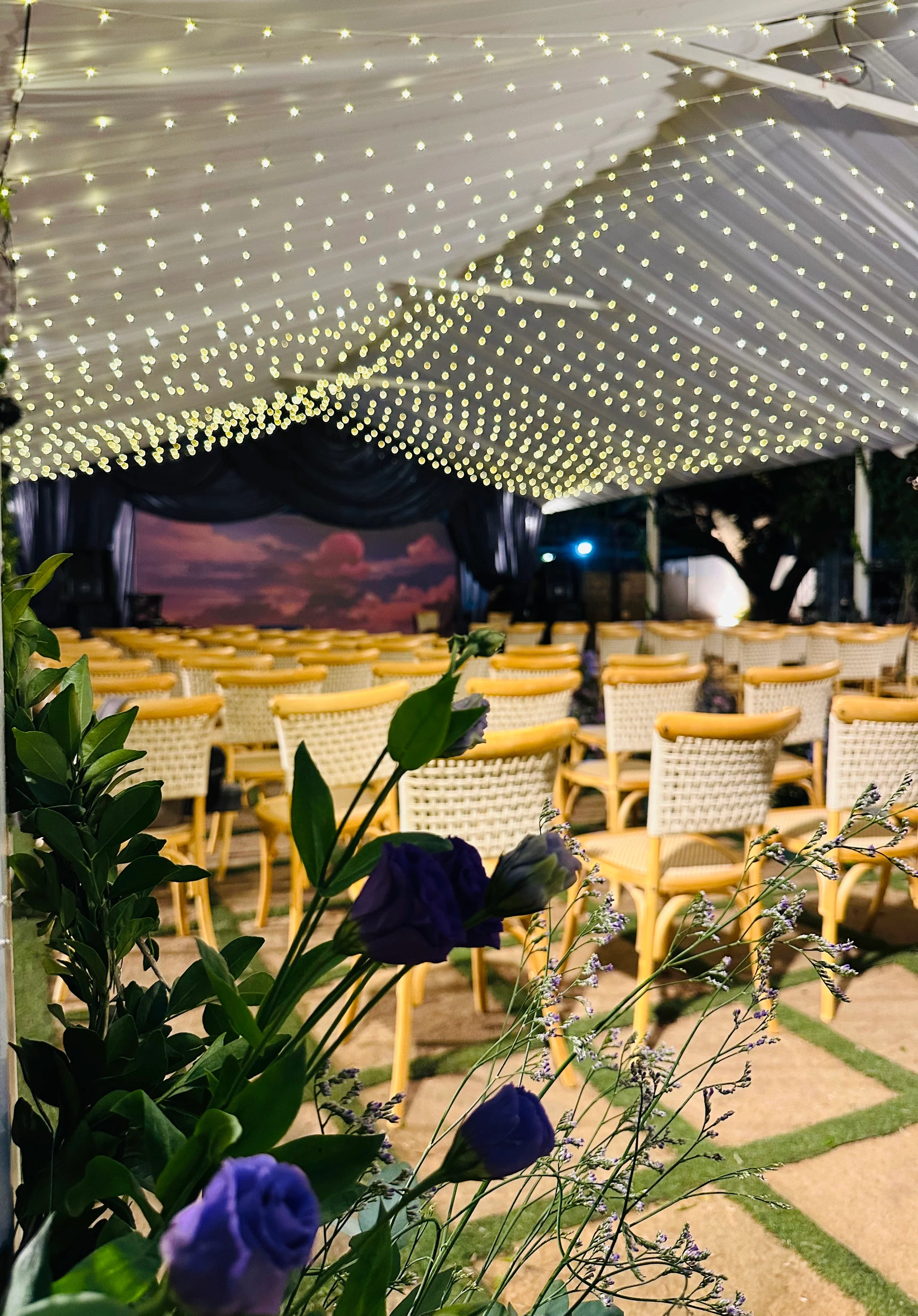 Outdoor wedding decor with elegant lighting and floral arrangements