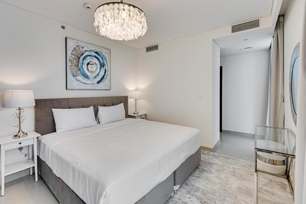 Contemporary condo interior with a living room and dining area, designed by Emaar, emphasizing modern aesthetics.