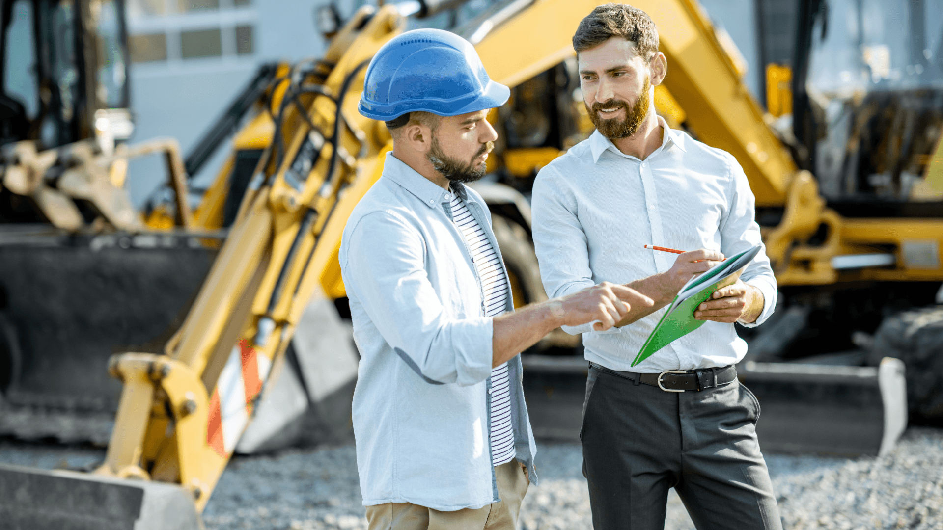 Construction professionals discussing plans on site, representing collaborative recruitment planning and resilience in UK construction hiring.