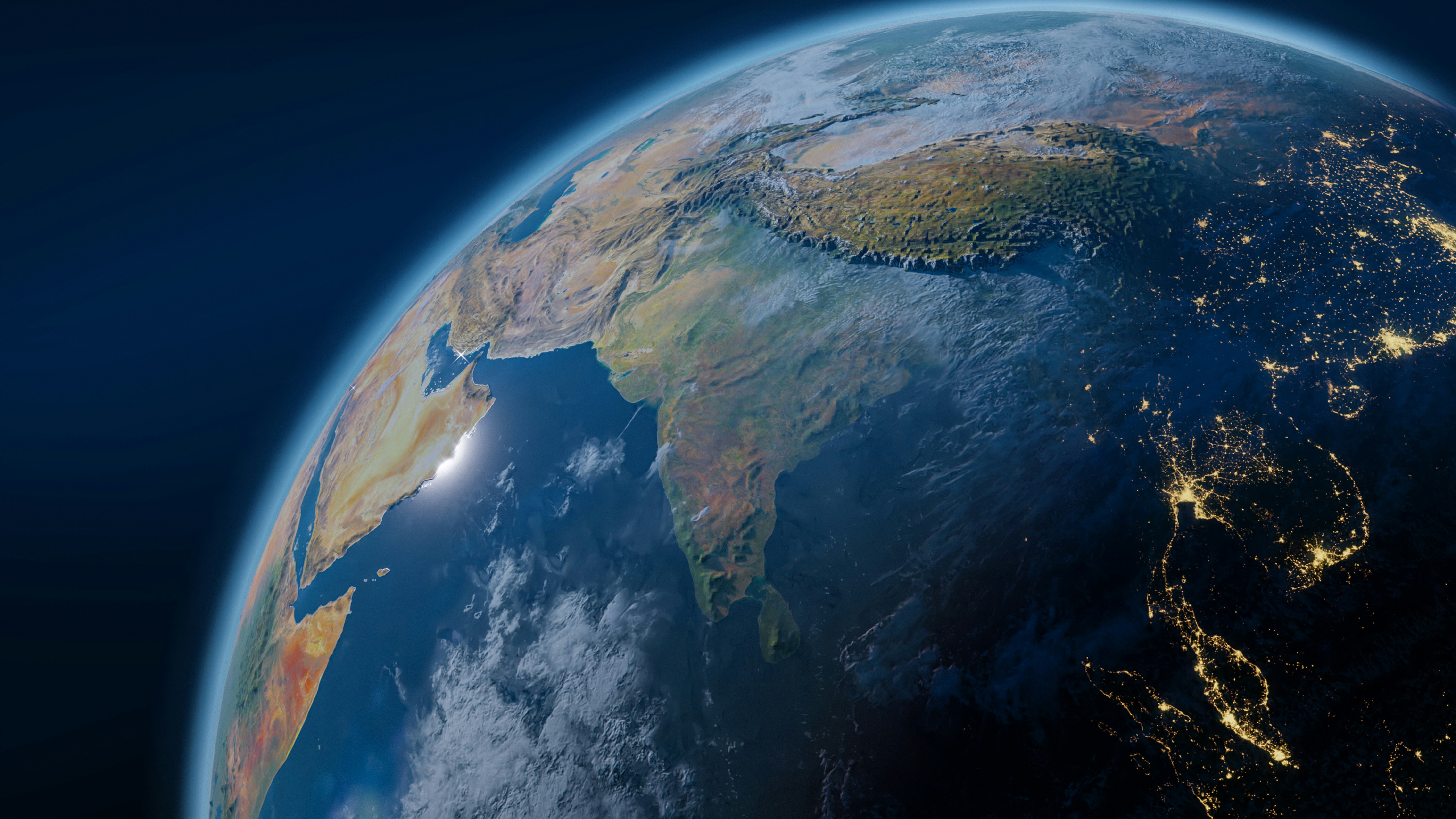 A view of Earth from space, showcasing continents and oceans against a dark background.