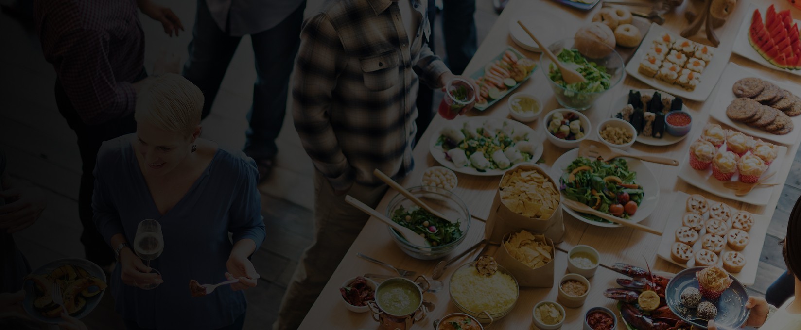 two people in a workspace working on their laptops