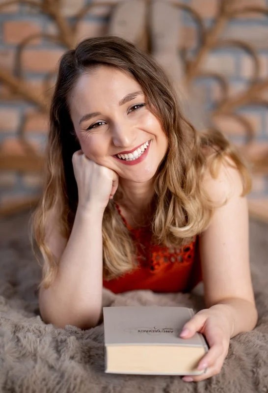 Írjunk könyvet kezdő kép, egy lány ül a széken.