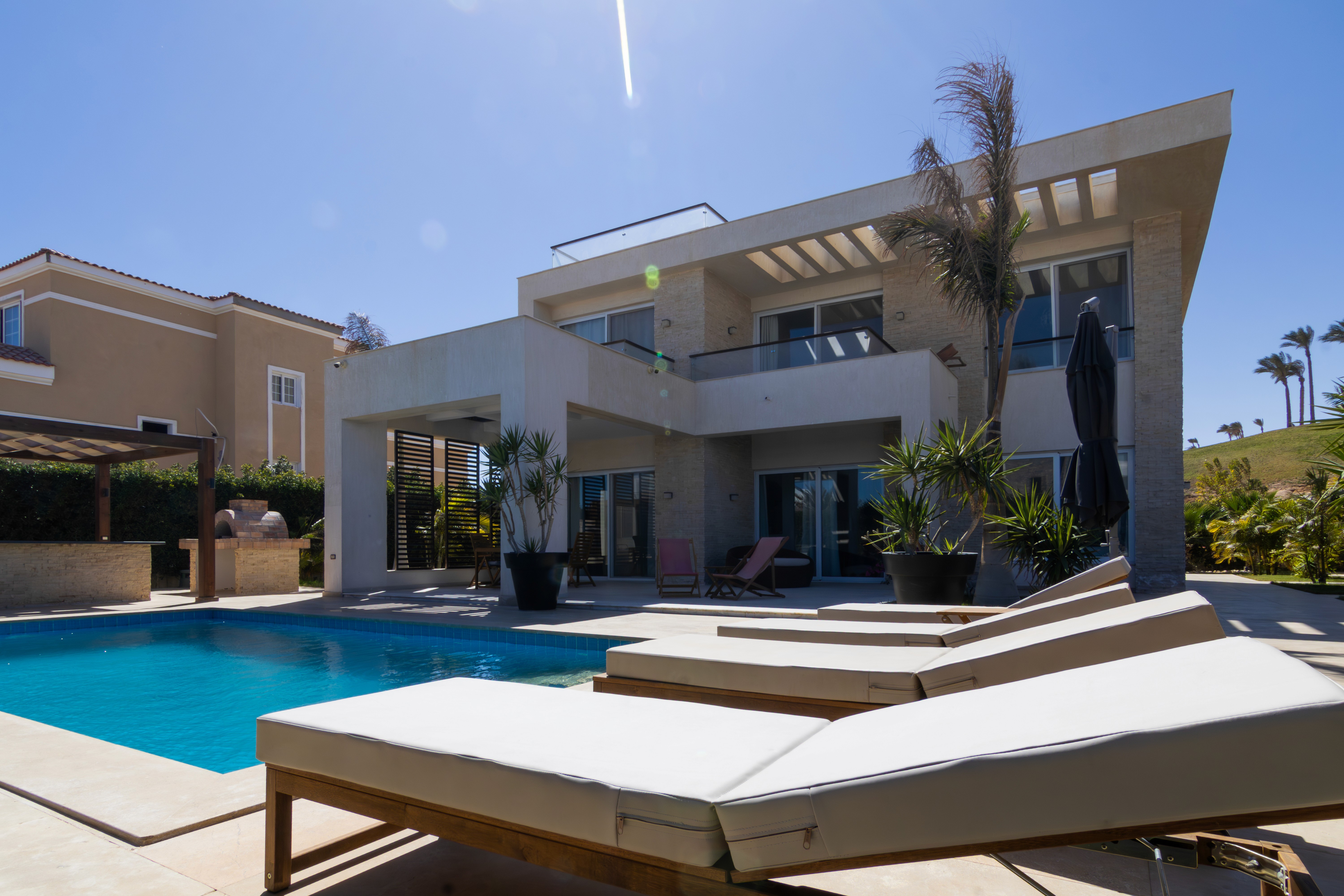 brown wooden house with green grass field