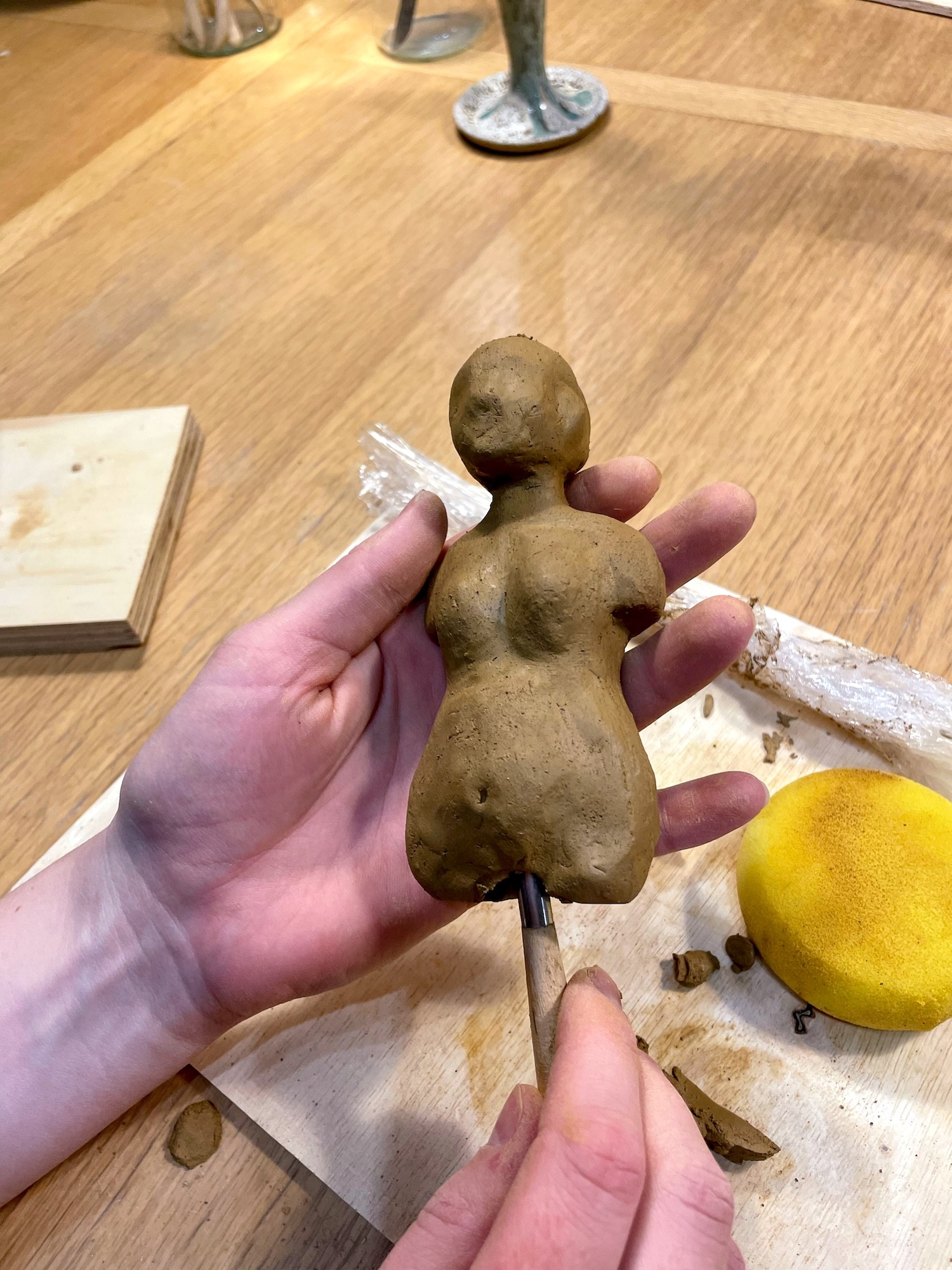 modelling a female body in clay