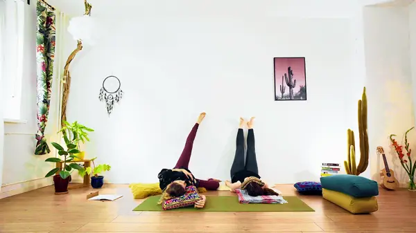 Pregnant woman in a restorative inversion yoga pose – prenatal yoga class to activate the vagus nerve and reduce stress for both mother and baby