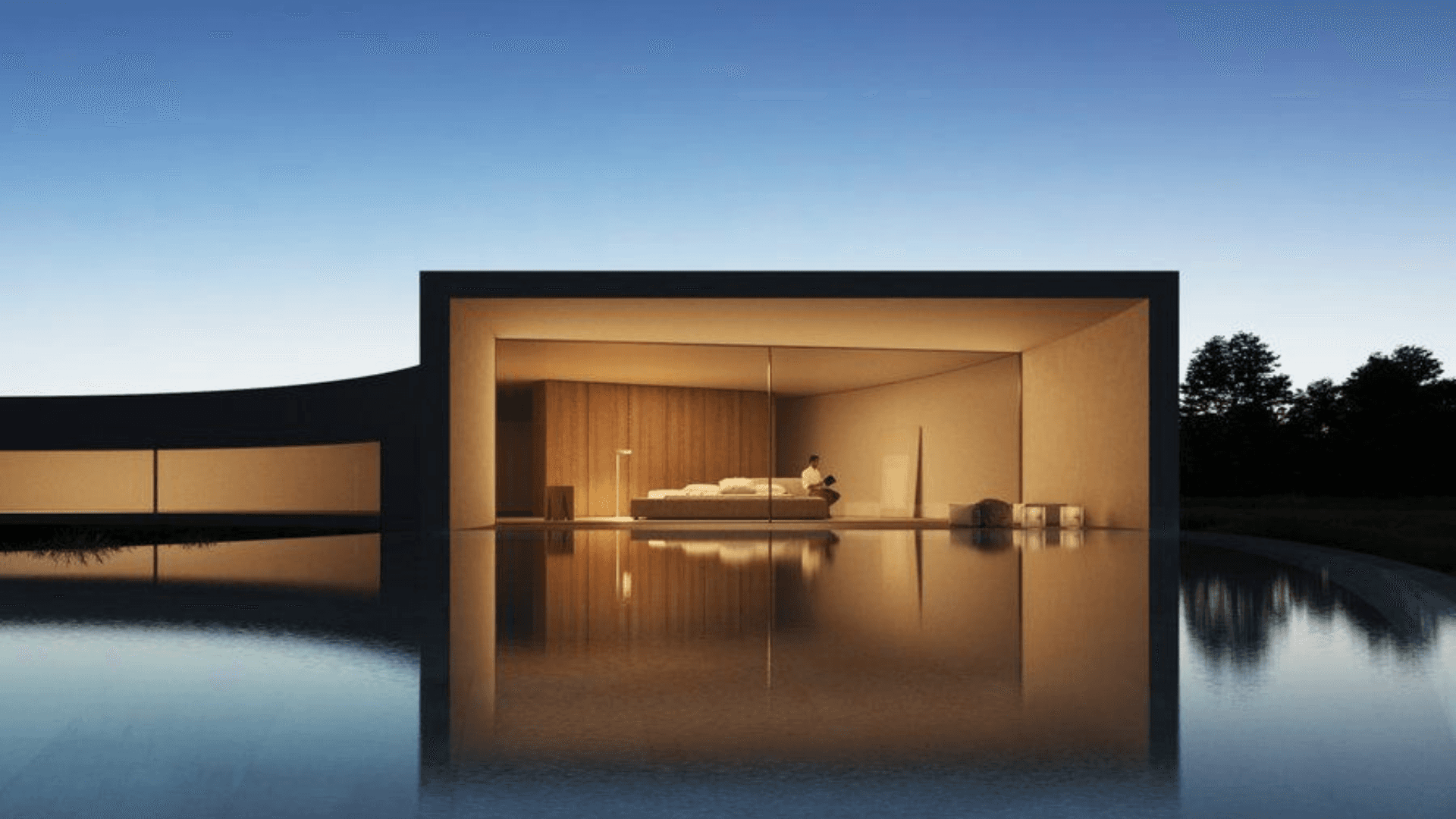 Glass-walled residence room reflected in a still pool at dusk