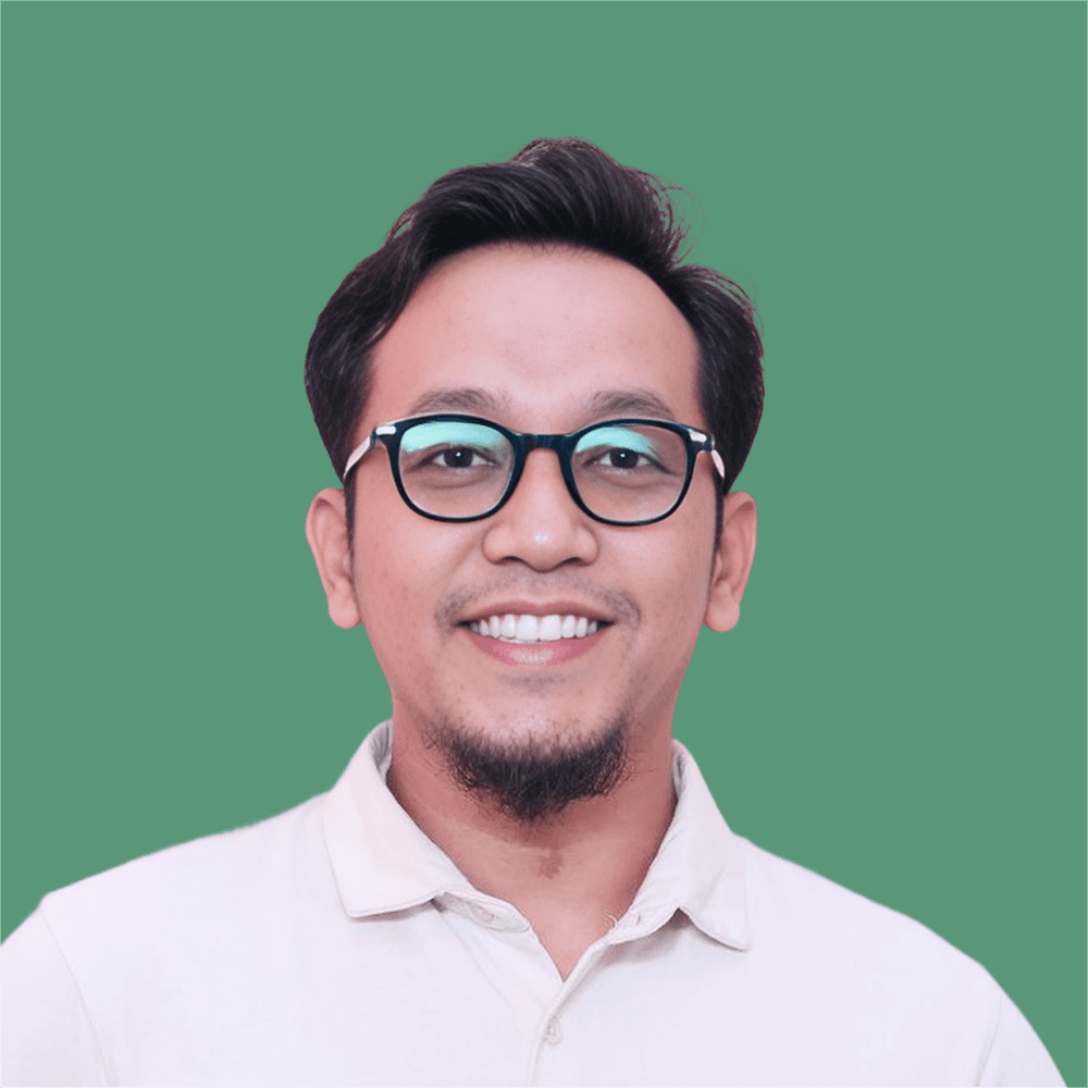 A young person with long, wavy hair sits in front of a plain background, looking directly at the camera.