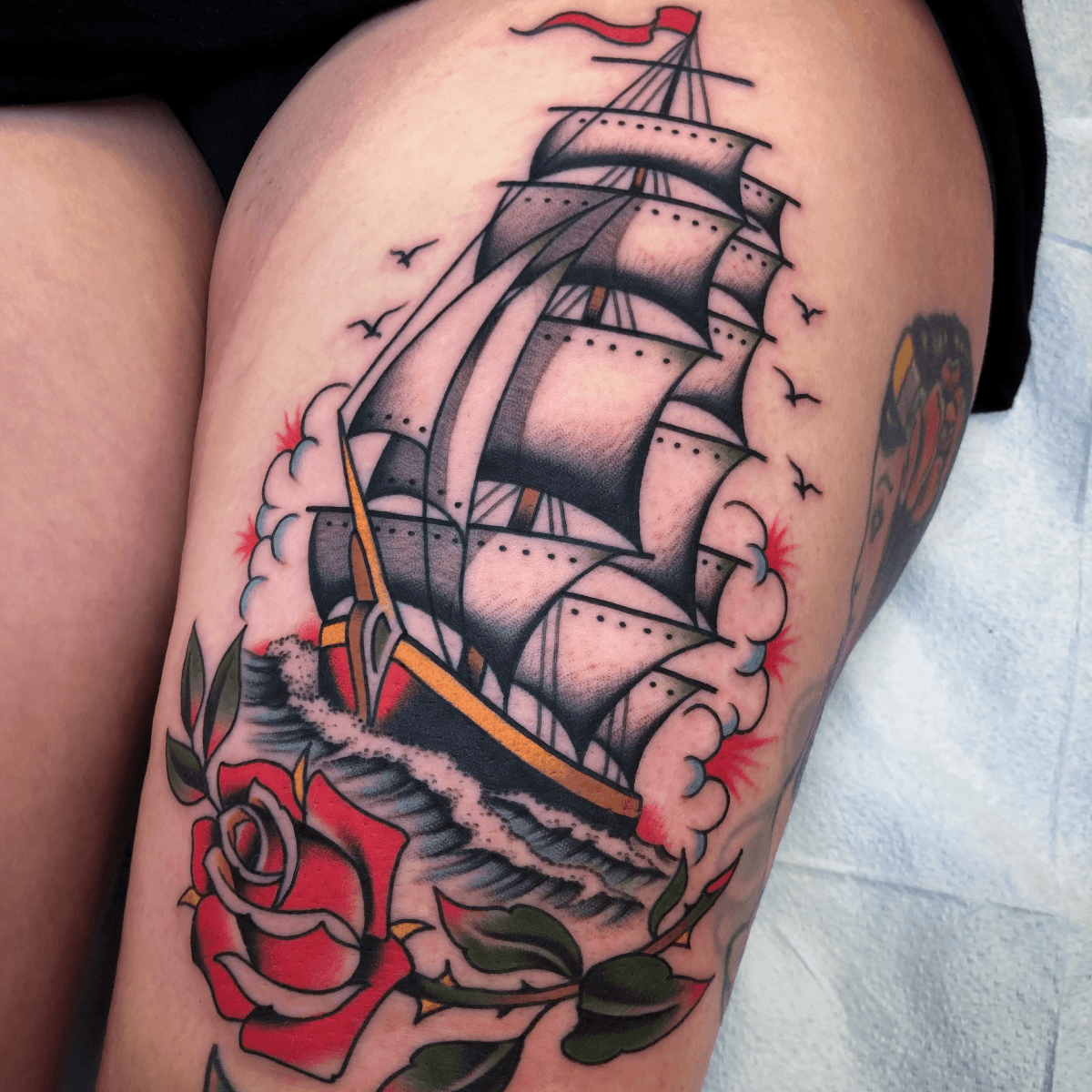 large color tattoo of a clipper ship and rose