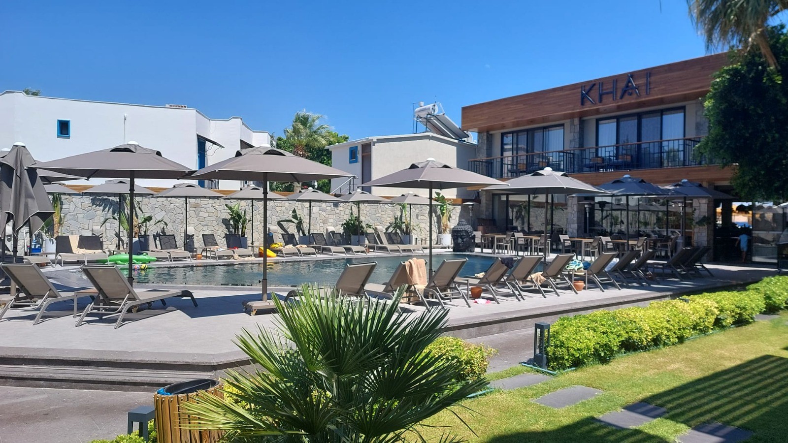 woman holding a phone and man looking at the phone. both are smiling