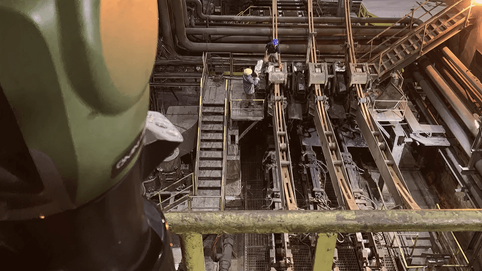 Autumn leaves frame modern city buildings under clear sky.