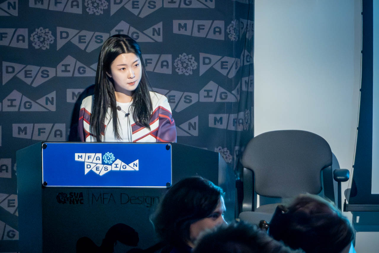 Woman at a podium delivering a presentation