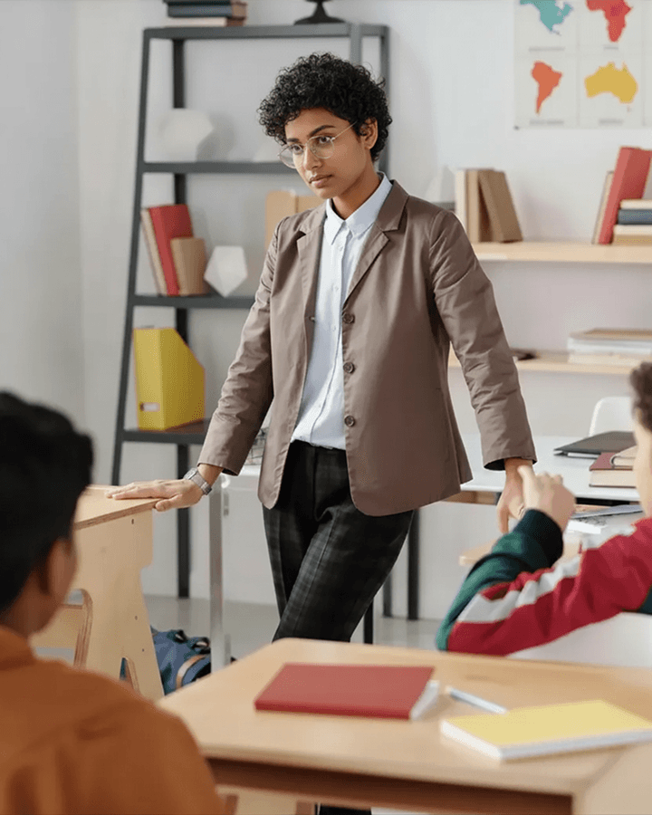 A vintage school bus is driving down the road