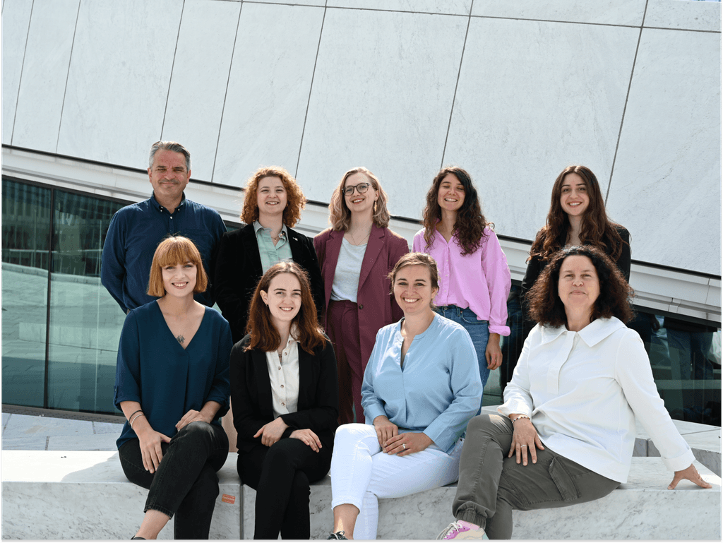 A triangular cabin with two beds looking out into nature
