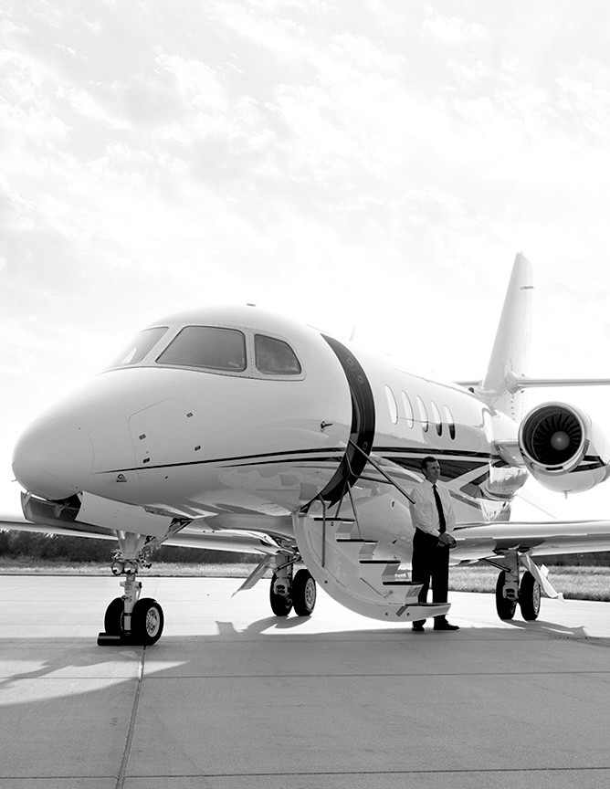  parked on the apron with the captain standing at the bottom of the stairs