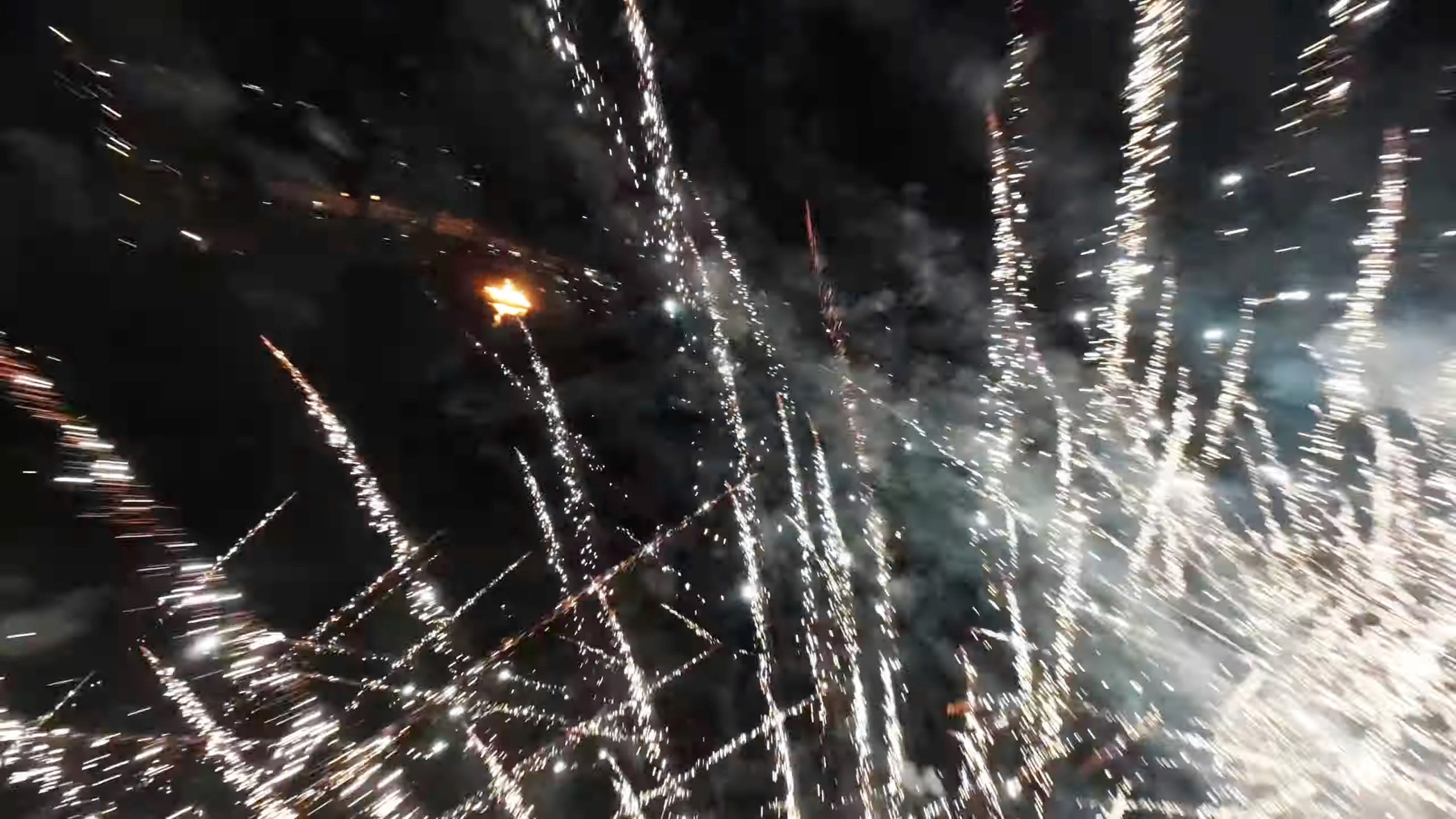 drone flying through fireworks mid explosion