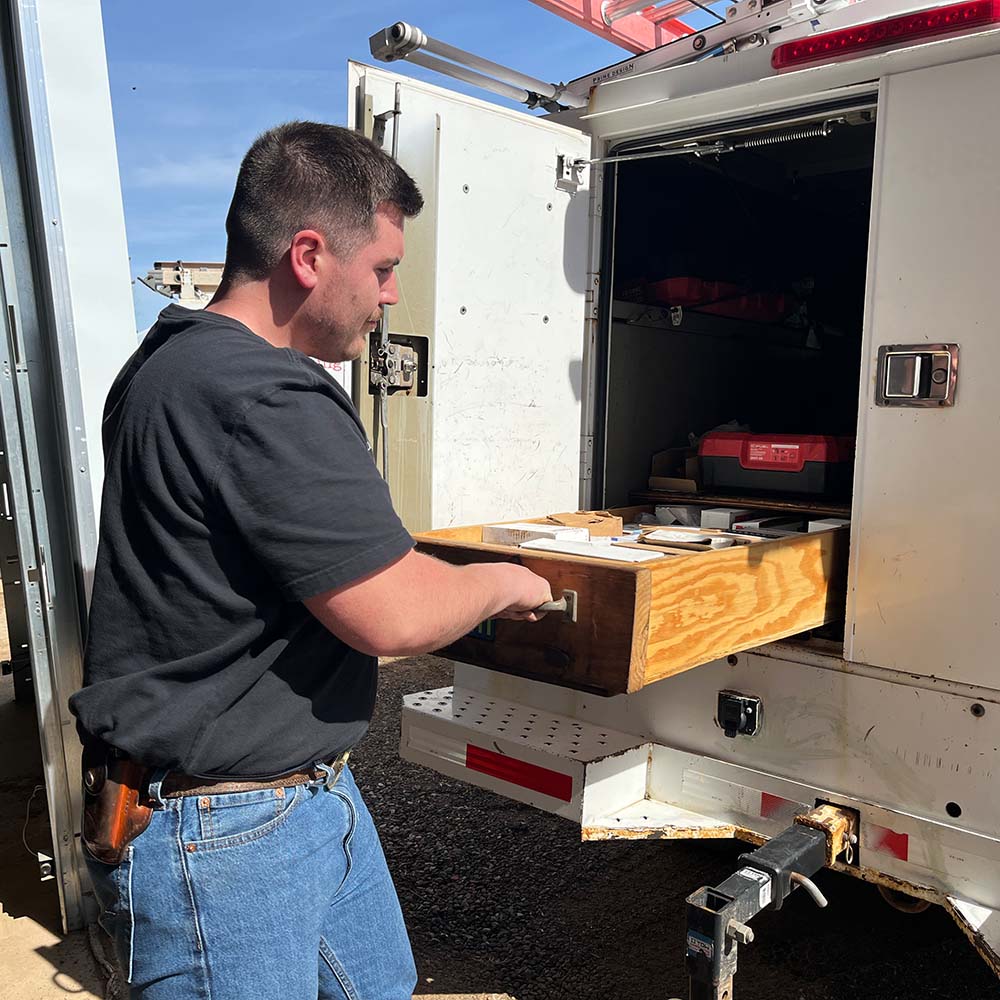 Sam DeVito pulling out drawer of tools on Brunswick service truck
