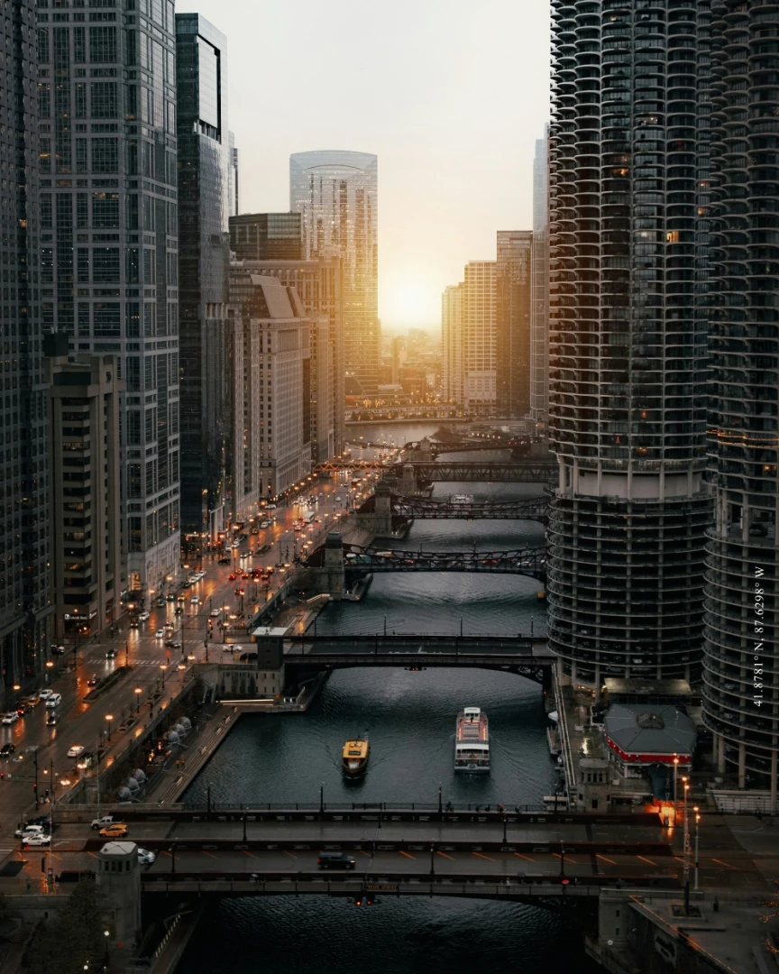 Cars on road between high rise buildings at dusk in downtown Chicago.