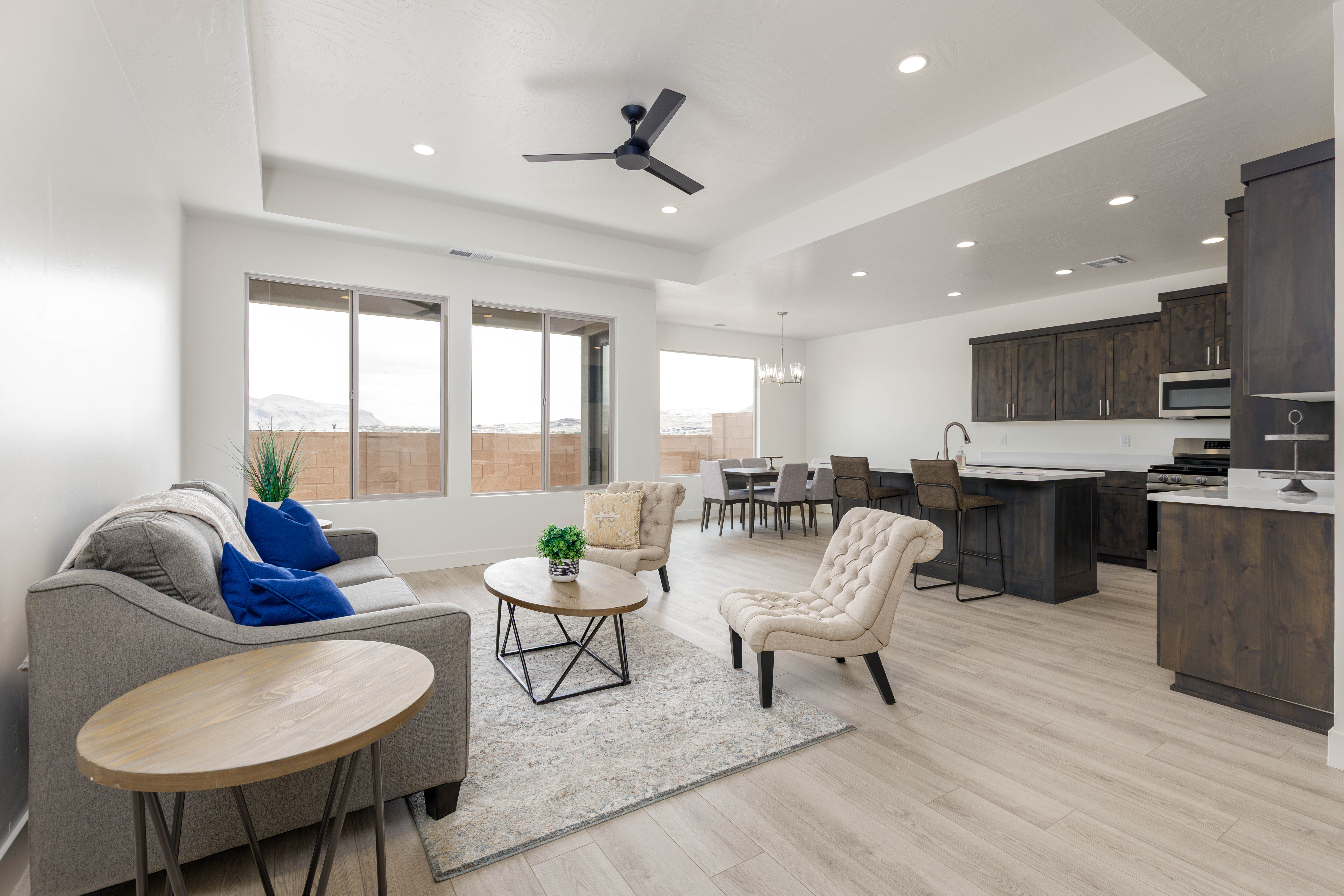 Great room with dark cabinetry accents and tray ceilings in Hurricane Utah new construction home.
