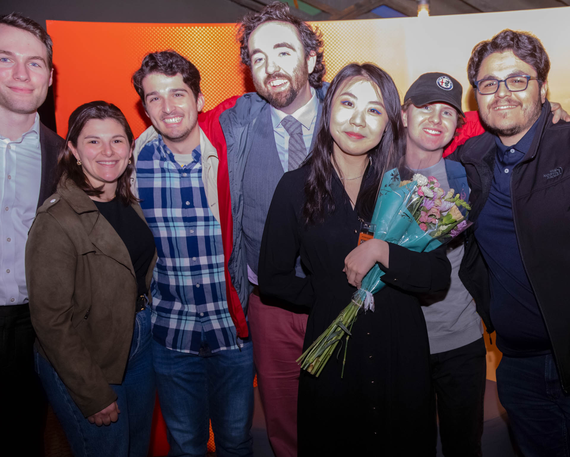 a group of students smiling for the camera in the SVA Theatre lobby after the Venture Forum