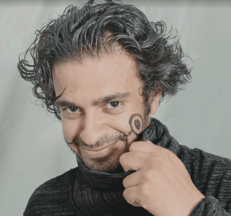 woman staring directly at camera near pink wall