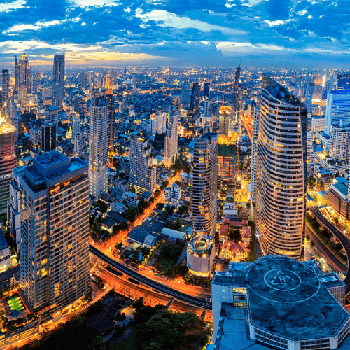 Serious woman centered among blurry hands holding up mobile phones.
