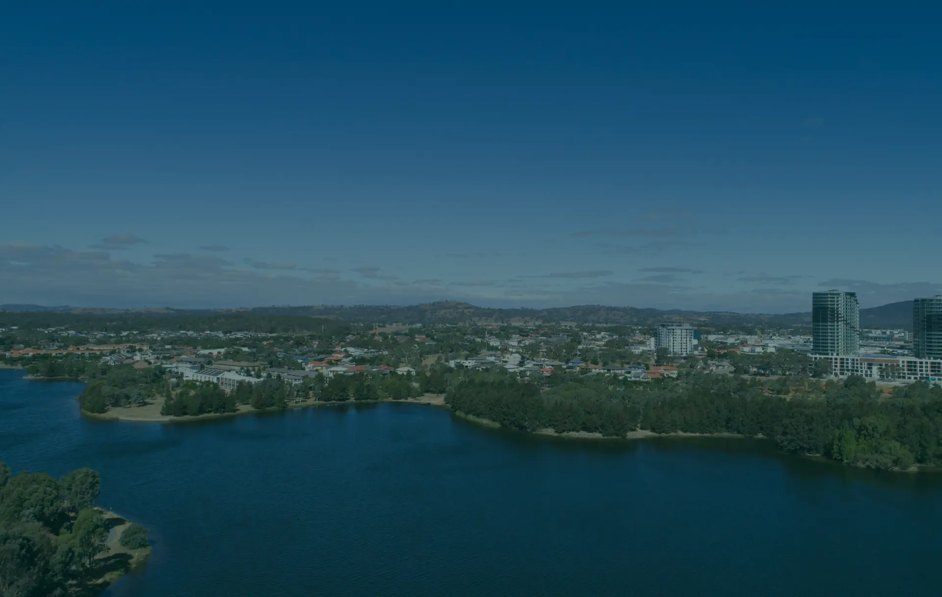 Waterfront city with high-rise buildings and hills