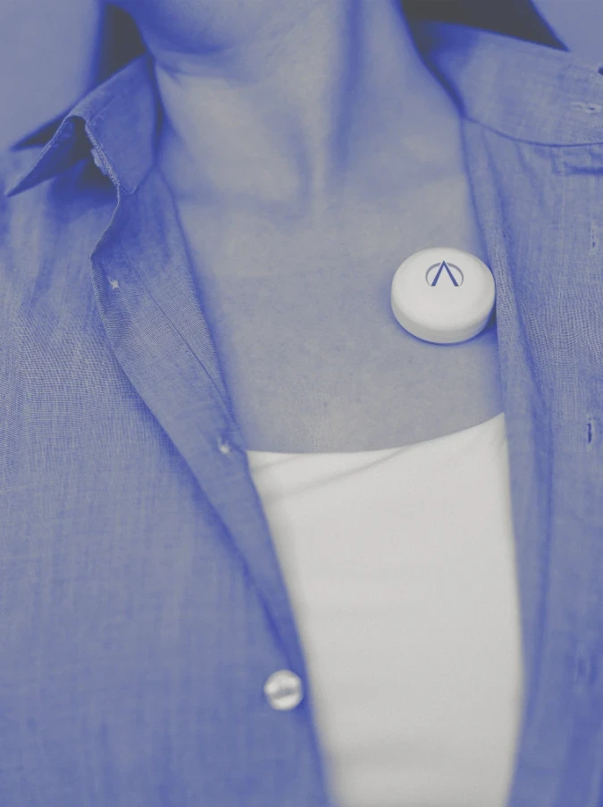 PneumoWave wearable respiratory monitoring sensor attached to patient chest, demonstrating connected health technology and remote monitoring.