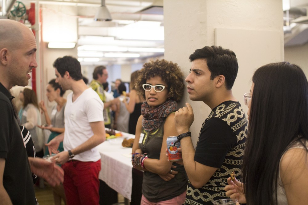 photo of some a few students talking to each other in the exhibition gallery