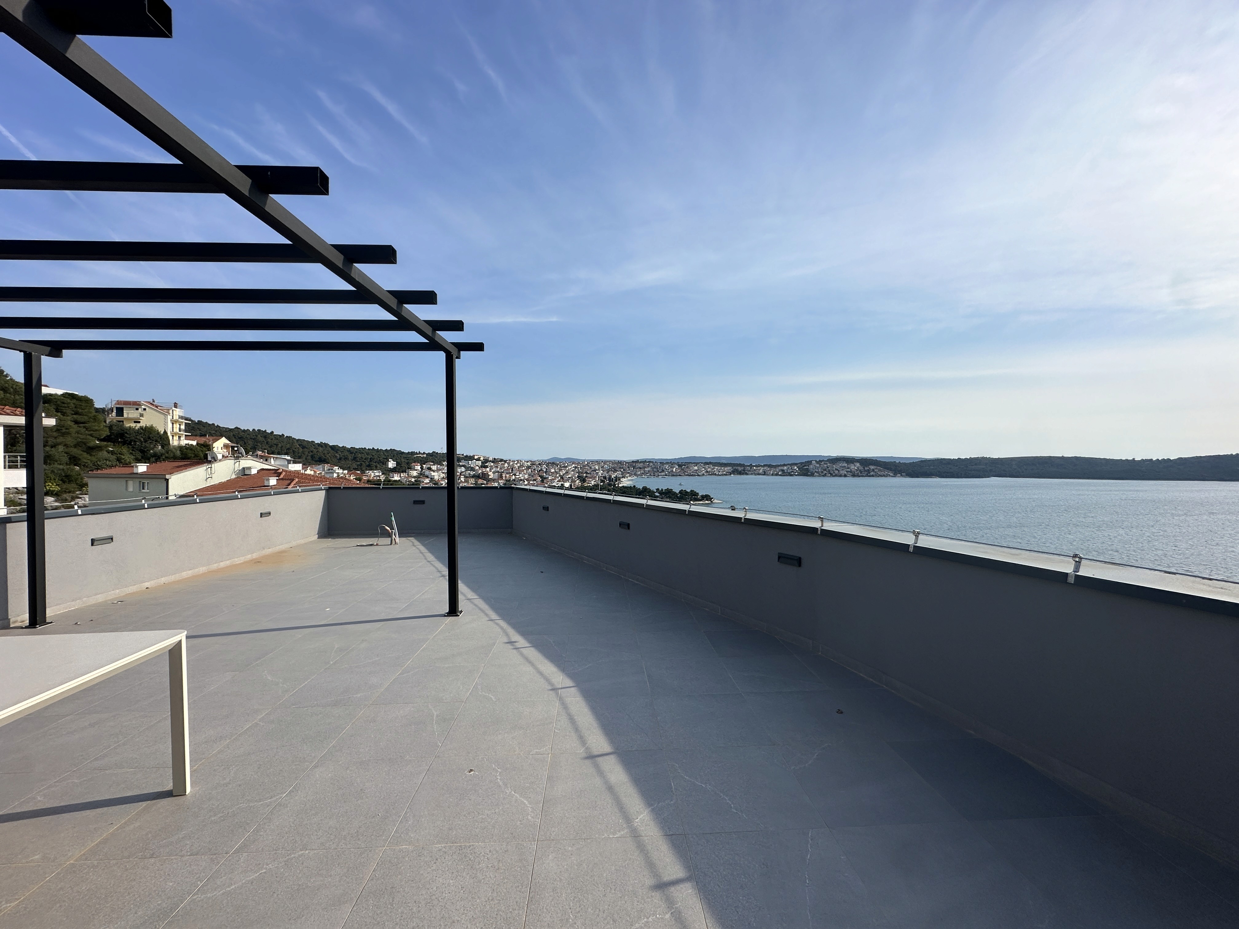 Bedroom with wall bookshelf and mountain view.