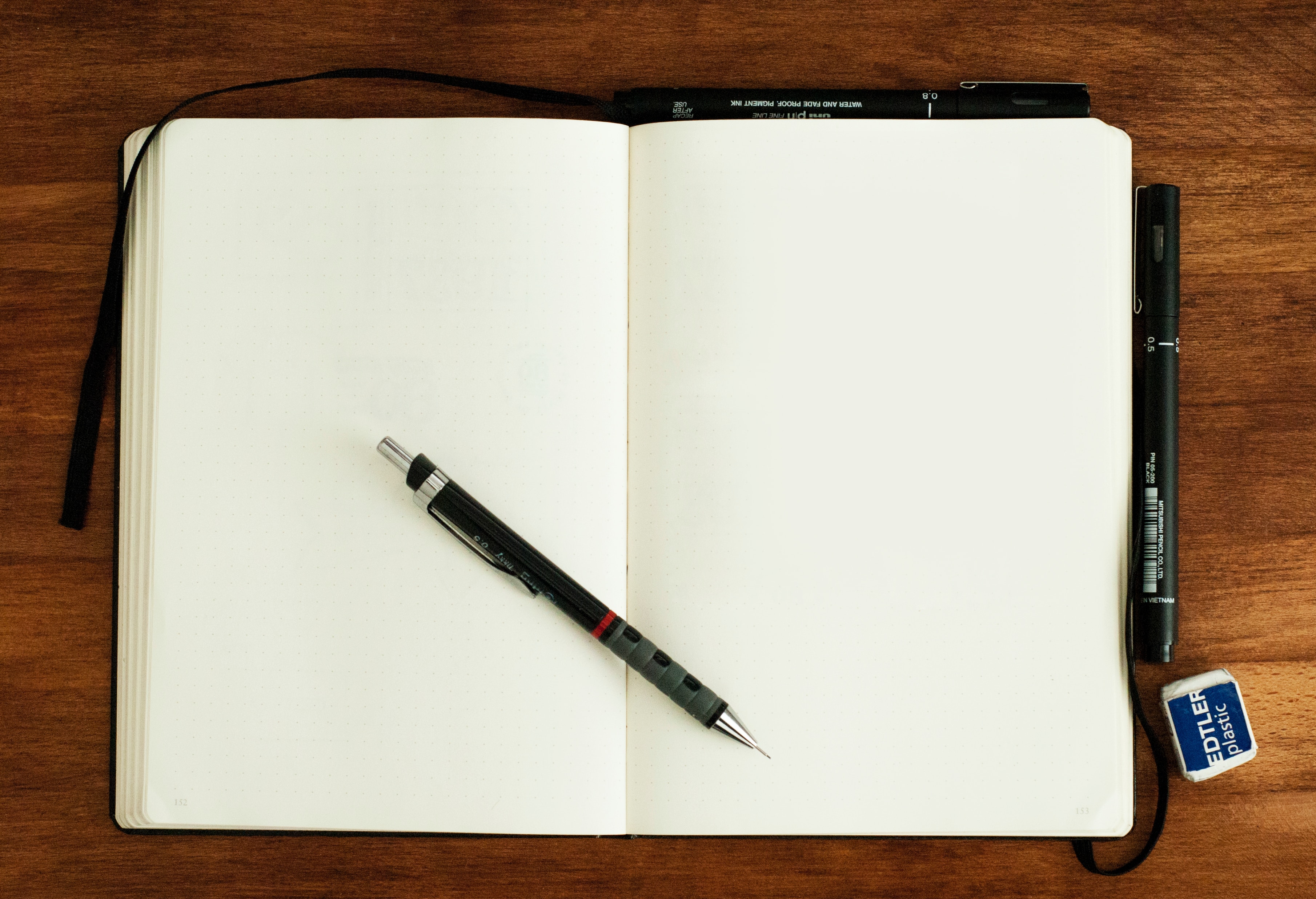an open book with a pen - how to write love songs