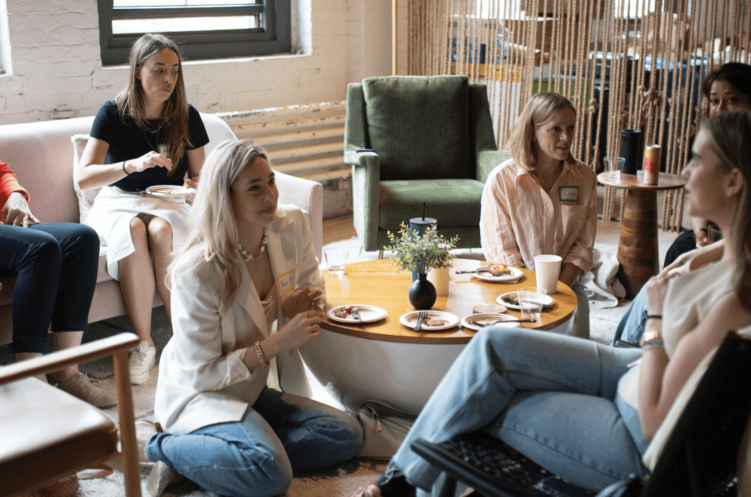 Group of women chatting around a table with food