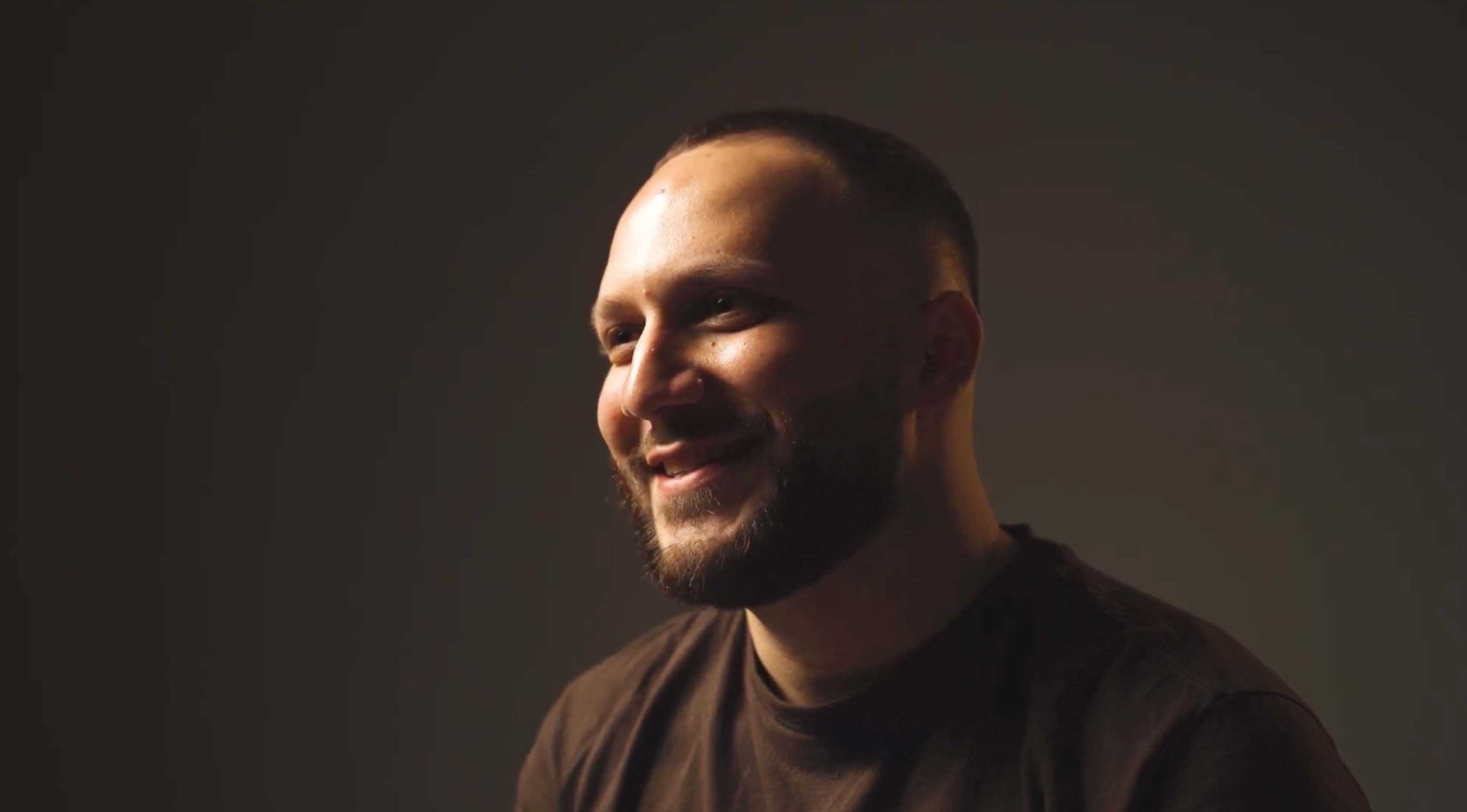 Cinematic overhead shot of a south asianwoman in a red outfit seated at a round table with traditional metal bowls.