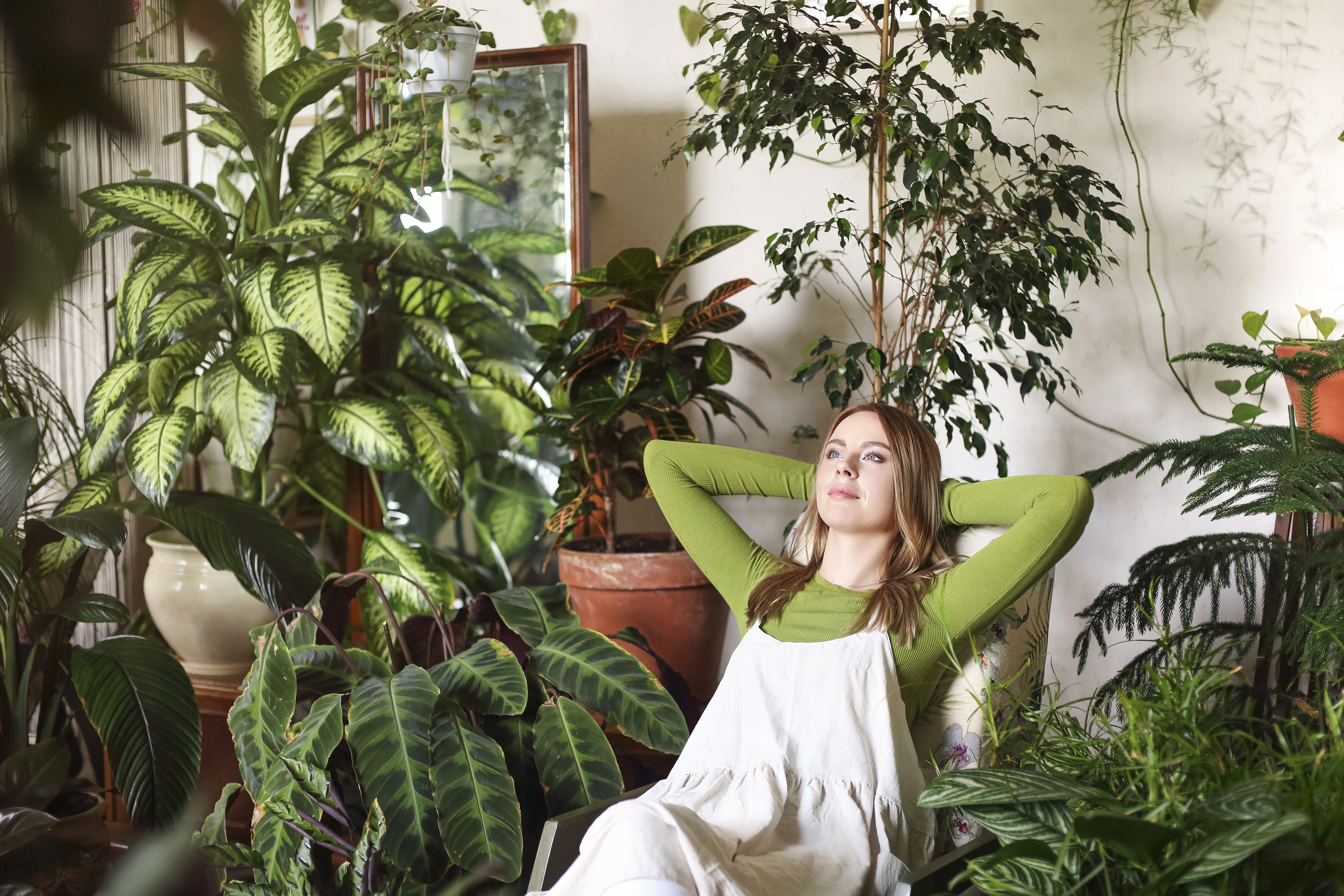 relaxed-woman-in-room-with-green-plants