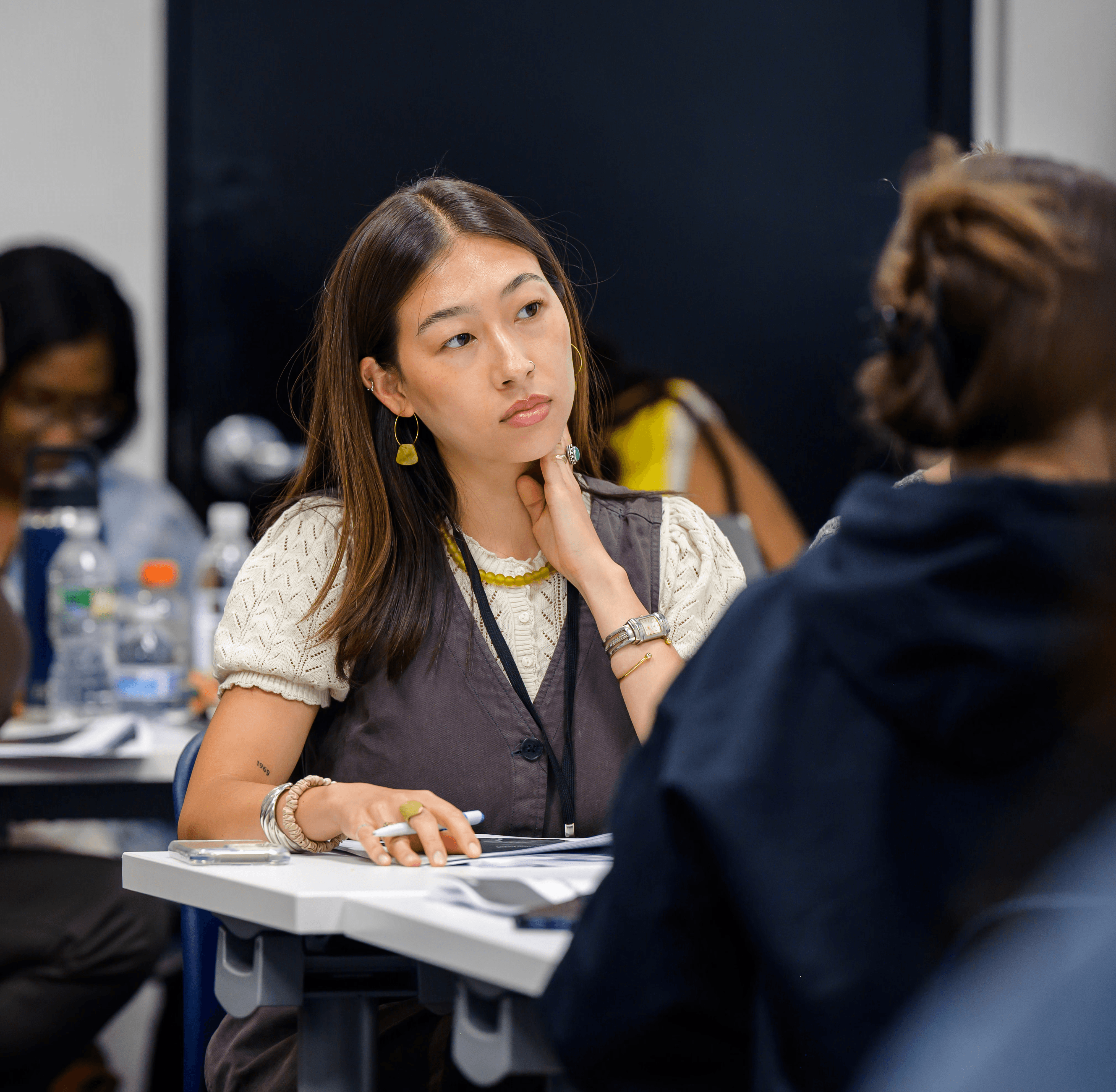 Photo of Teaching Lab Studio member at workshop observing speaker.