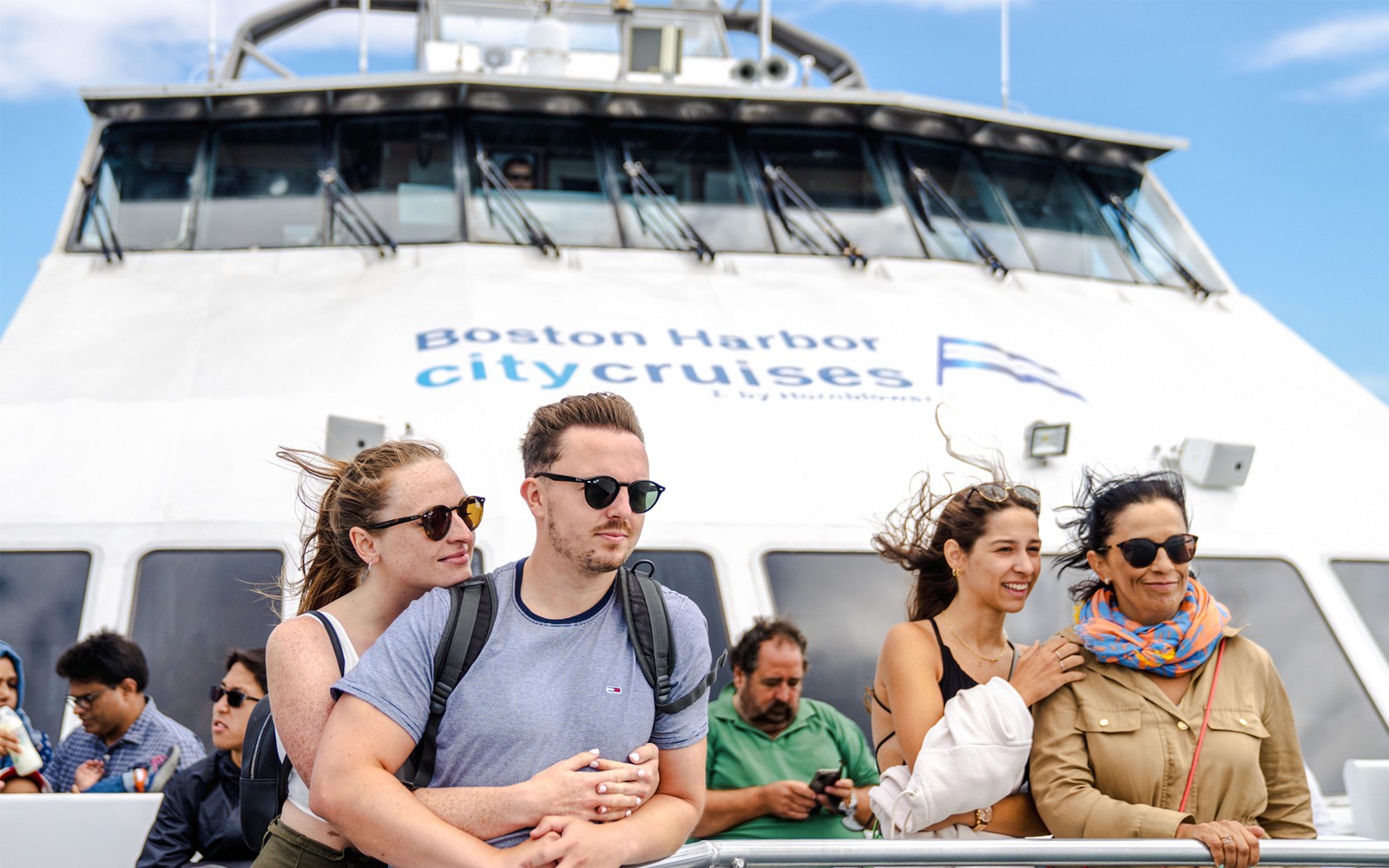 Guests enjoying a whale watching cruise on an England Aquarium tour.