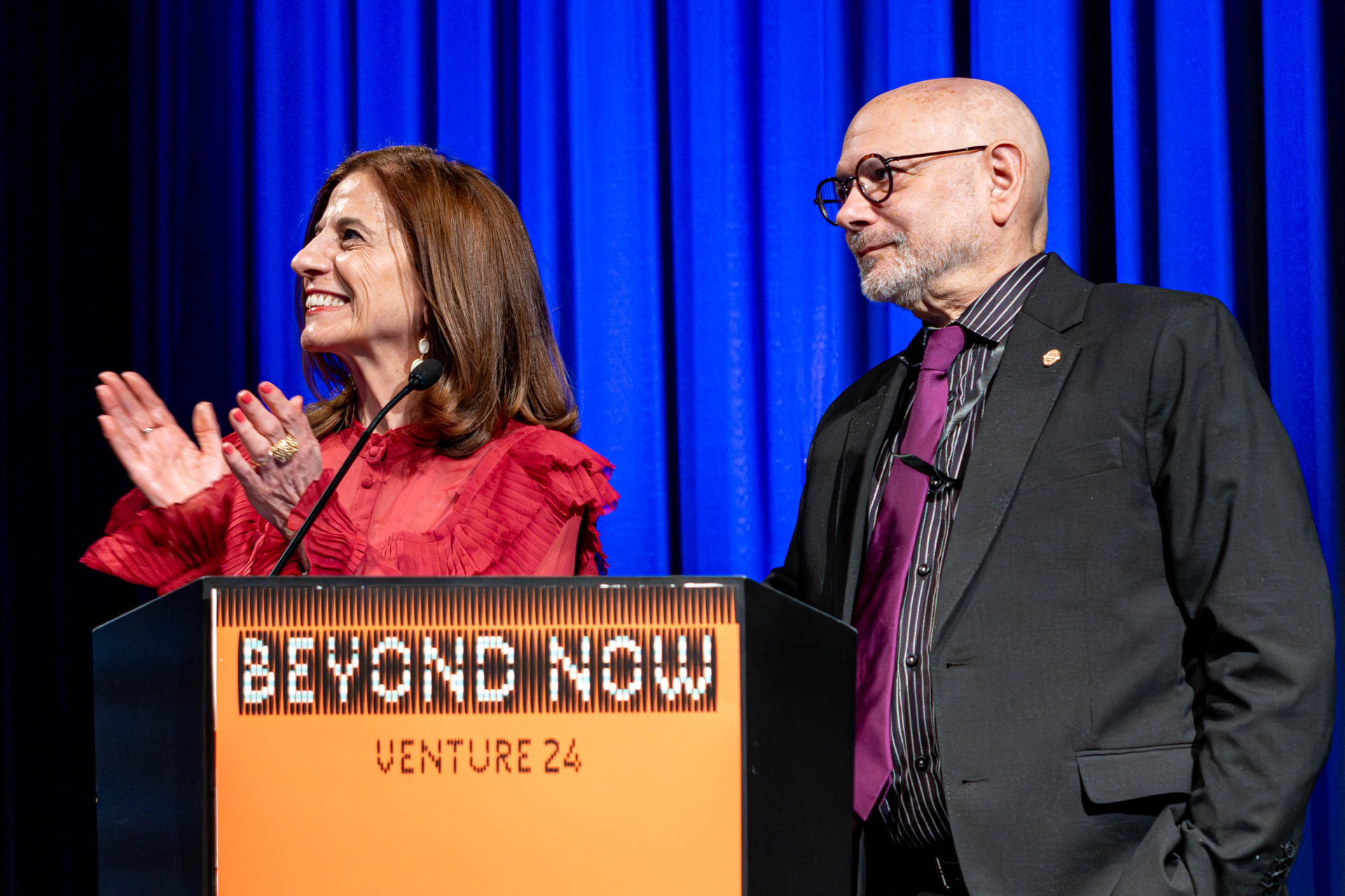 two people at a podium presenting
