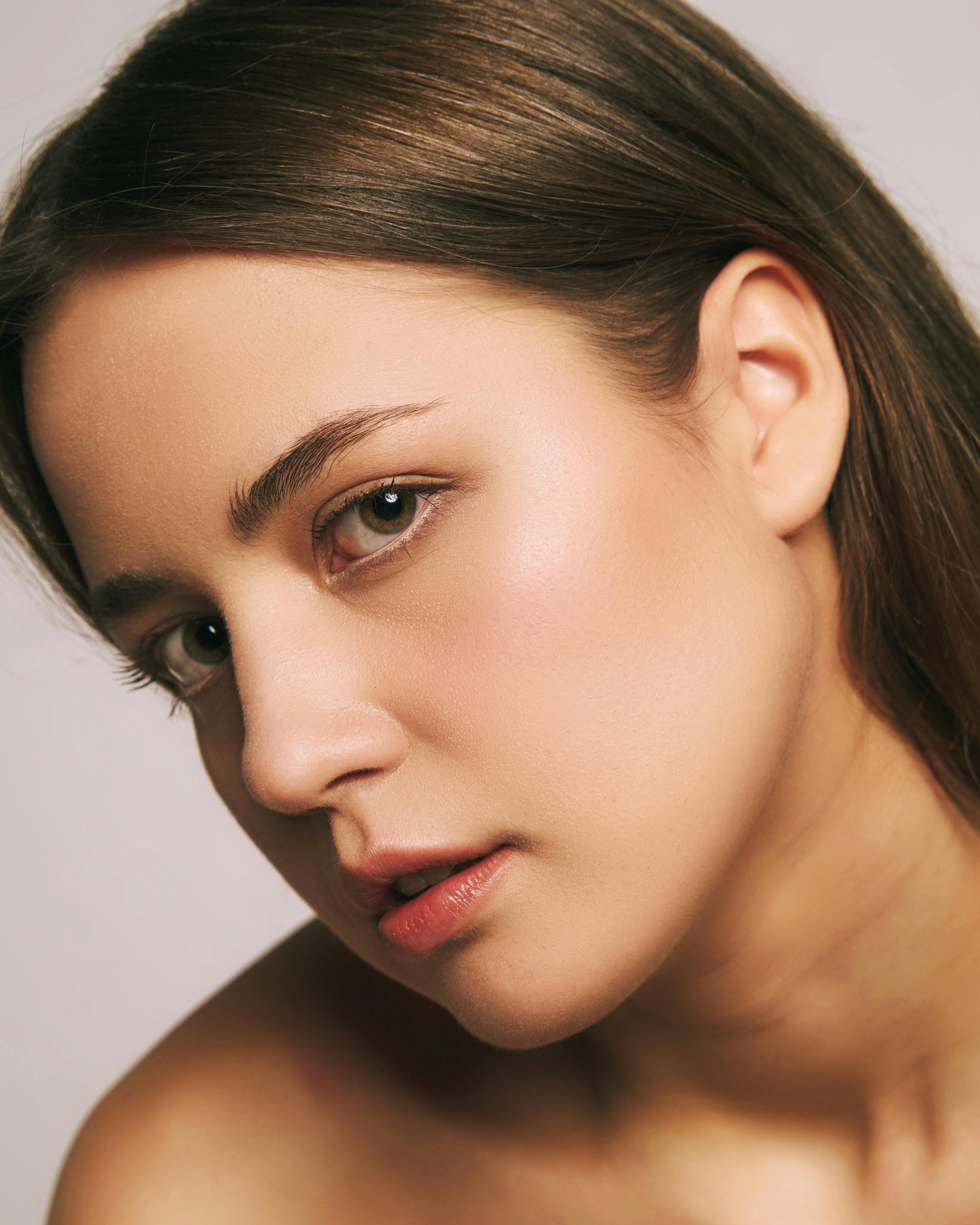 Beautiful lady with a ray of sunlight shining on her face