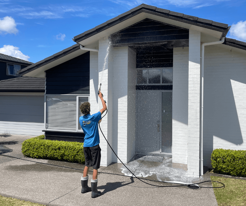 Asher completing final rinse on home exterior