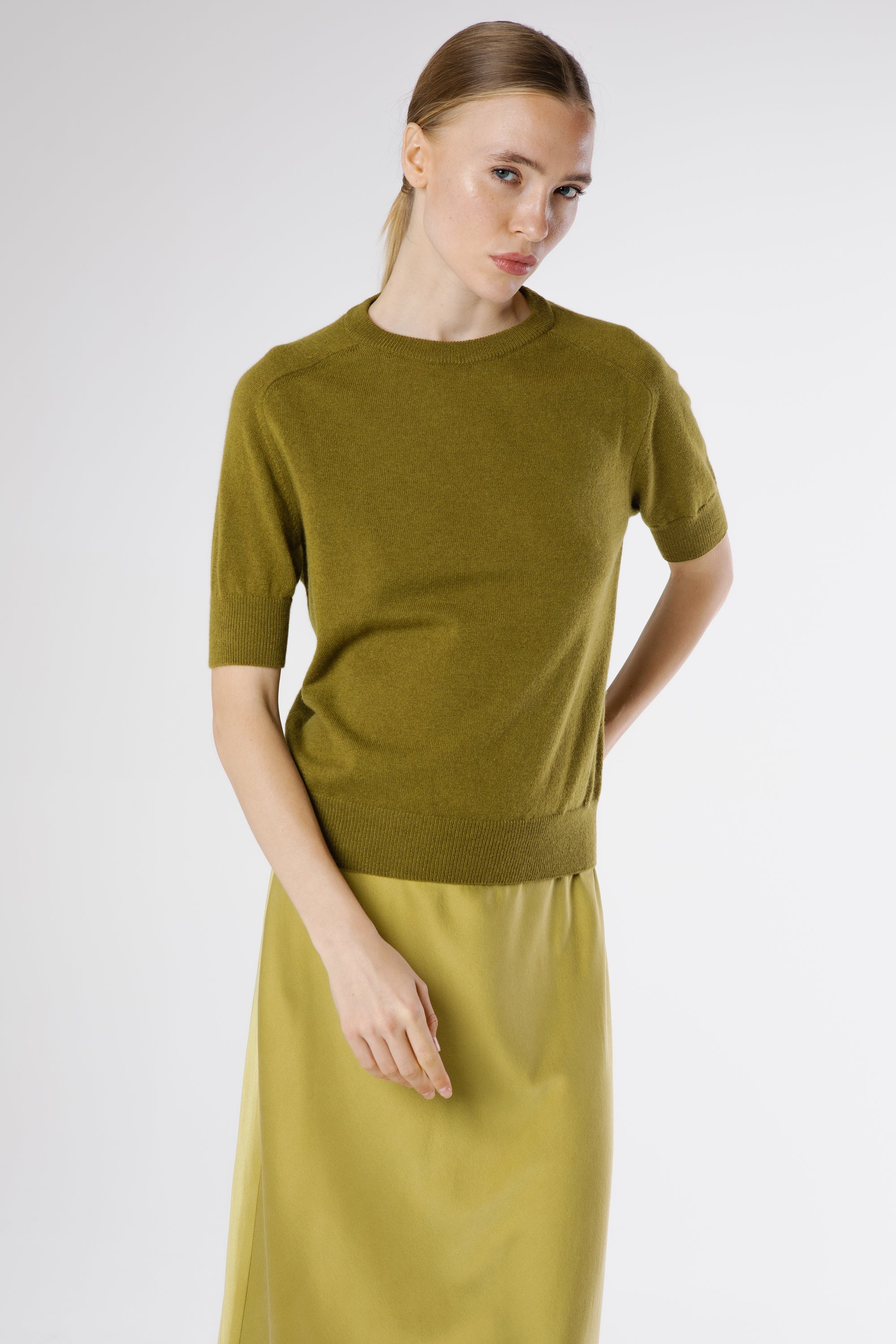 Side profile of the Magda Cashmere Pullover Juniper revealing its flattering fit and soft, lightweight drape.