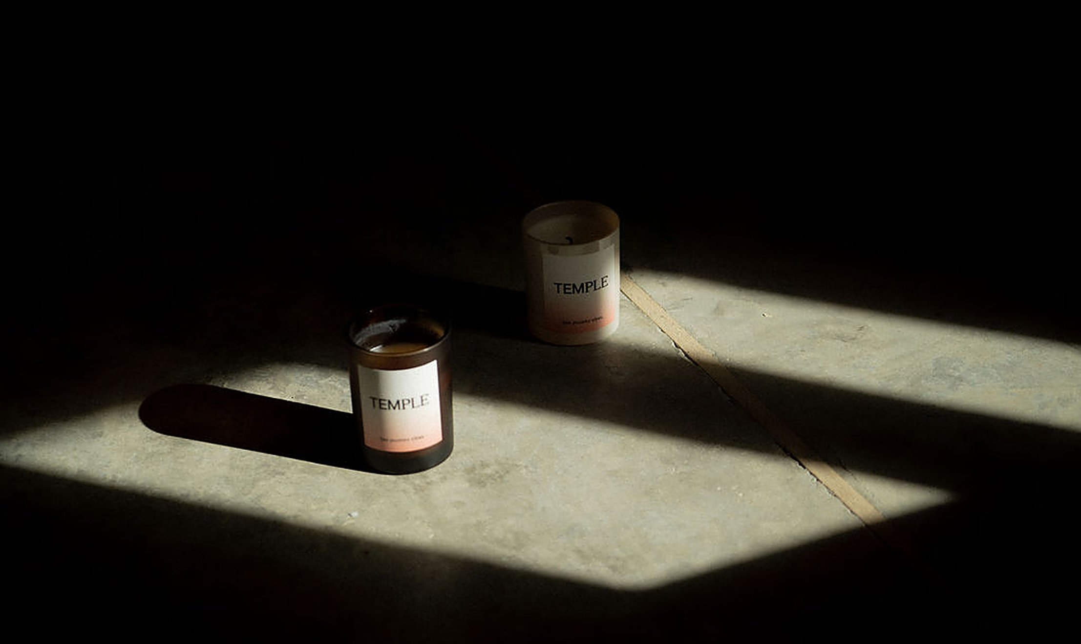 Two Temple candles in soft window light, the calm and cozy mood of learning through online intimacy courses at home | My Temple