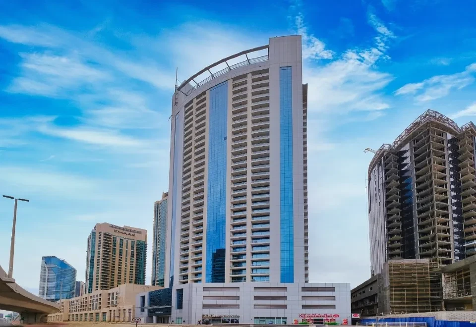 Burj Al Nujoom tower in the city. Professional real estate agent services for property investment in Dubai.