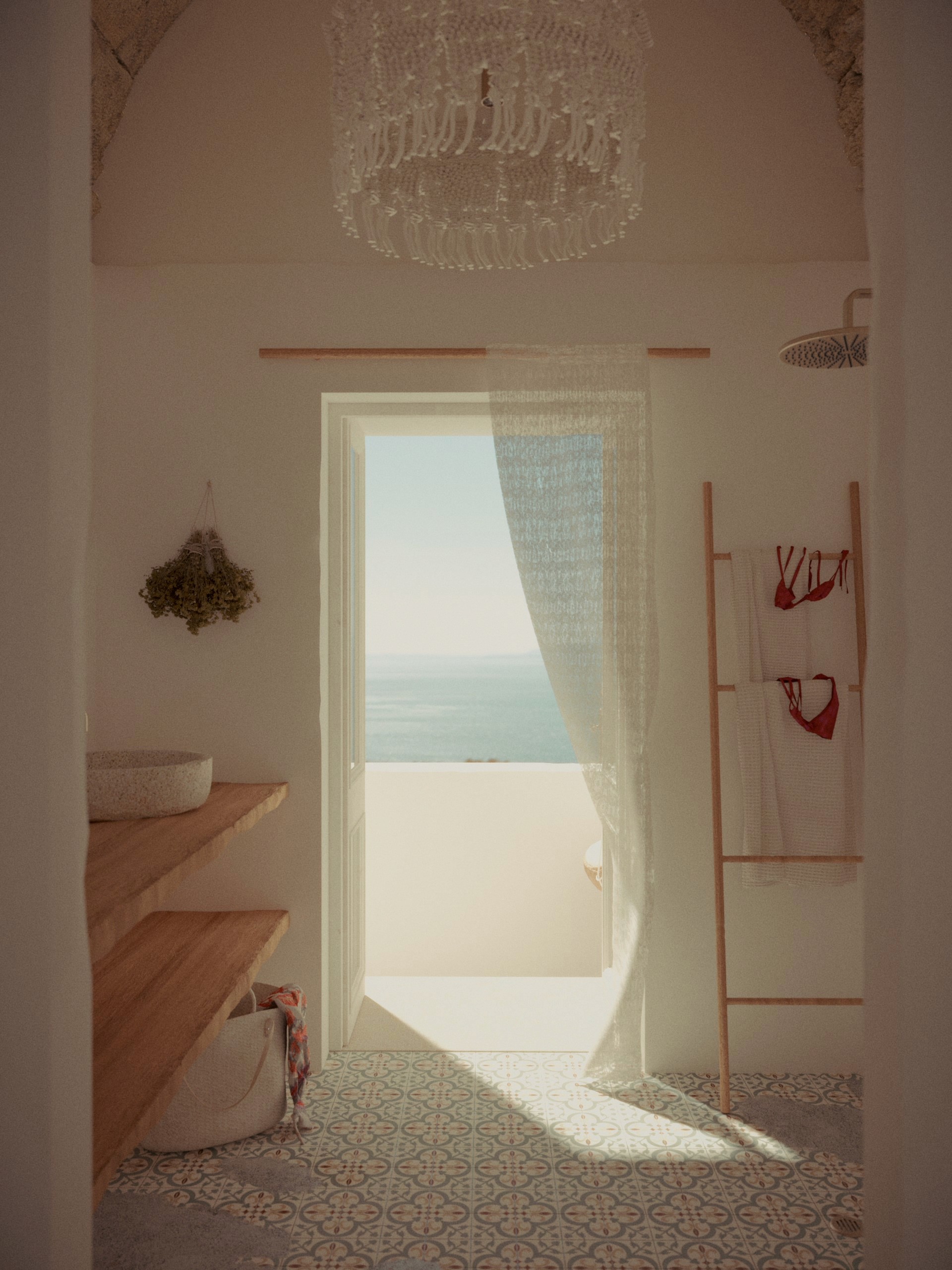 Bagno con pavimento in cementine, doccia a pioggia e tenda di pizzo alla porta-finestra sul mare