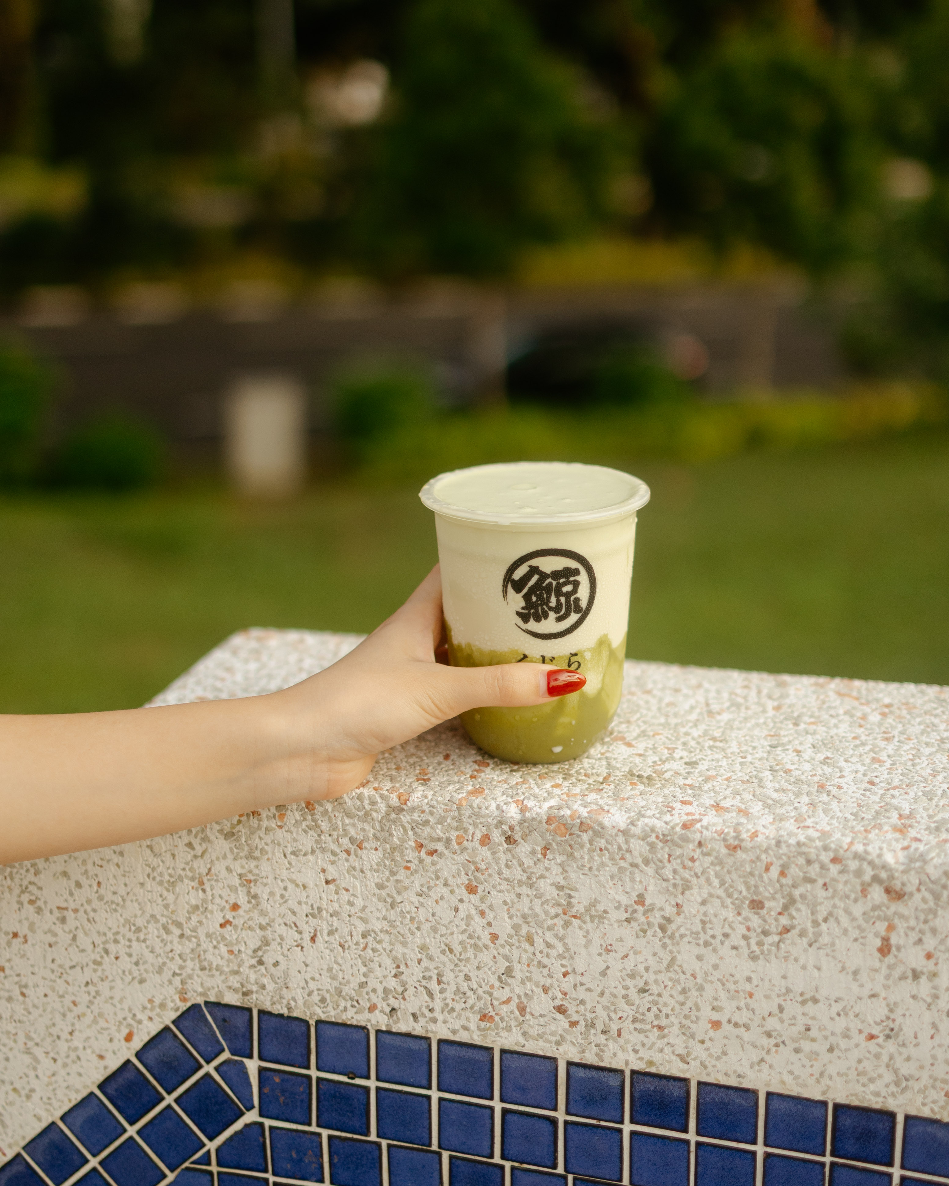 Product and beverage photography in grass field in Singapore for marketing